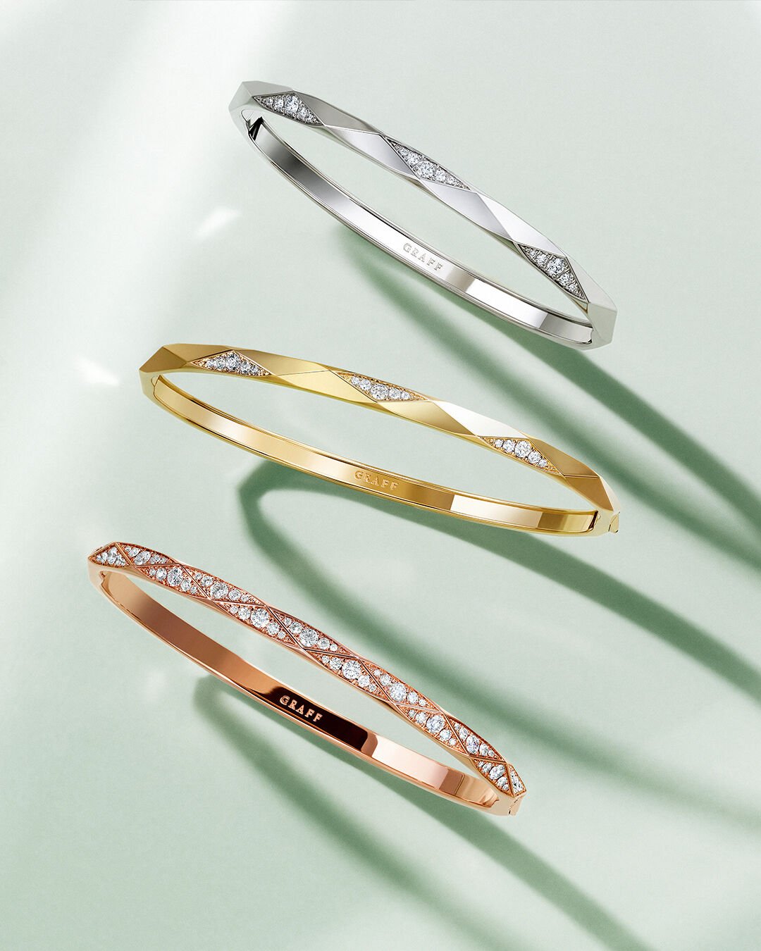 Image shows model wearing Laurence Graff Signature bangles and rings 