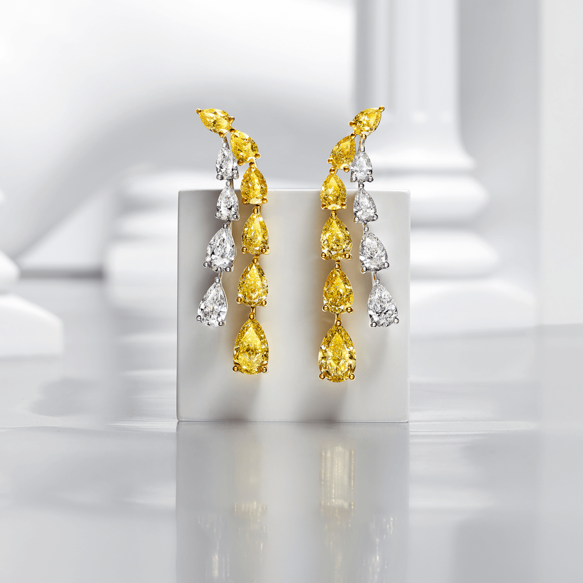 Graff Yellow And White Pear Shaped Diamond High Jewellery Earrings inside a Gallery