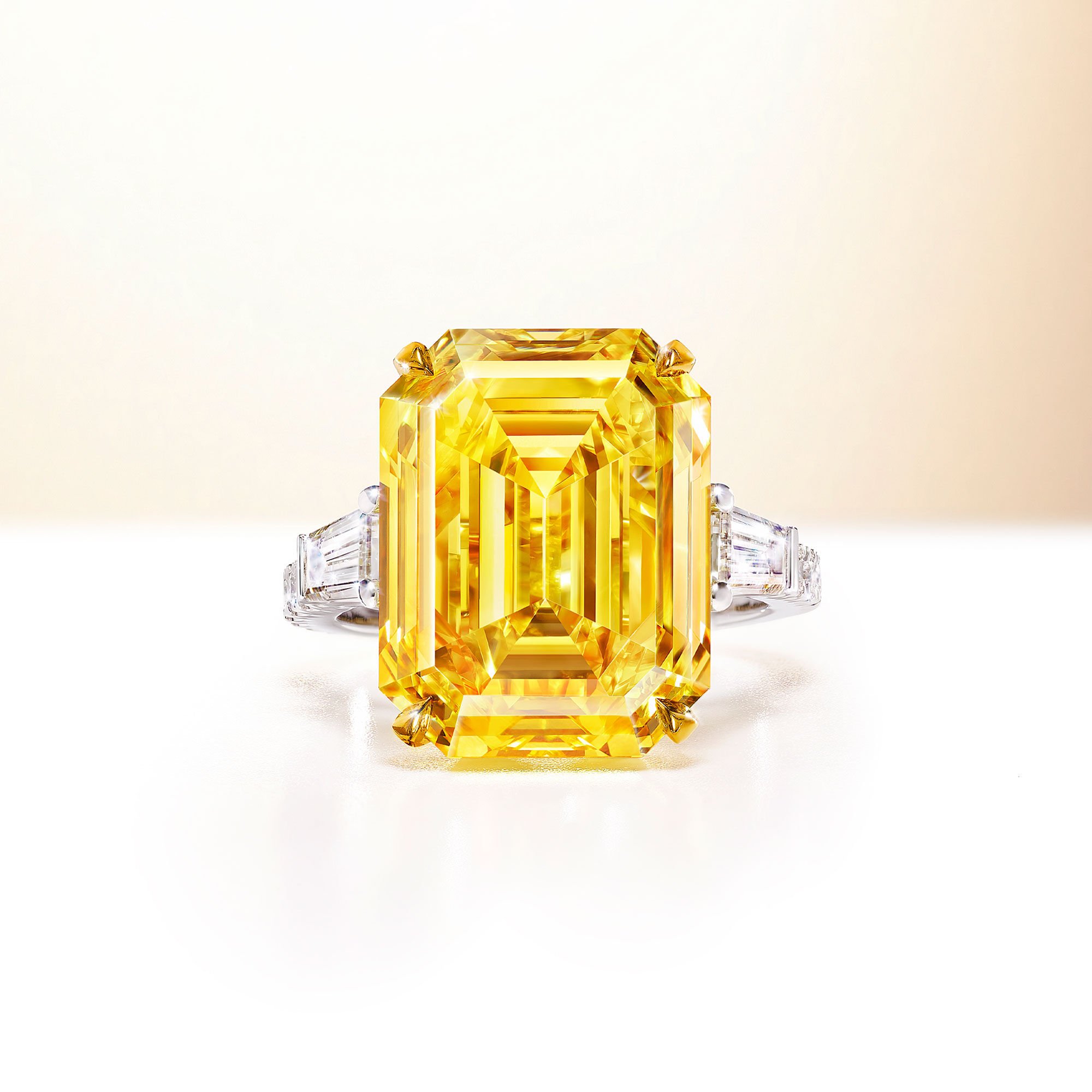 An emerald cut yellow and white diamond ring by Graff