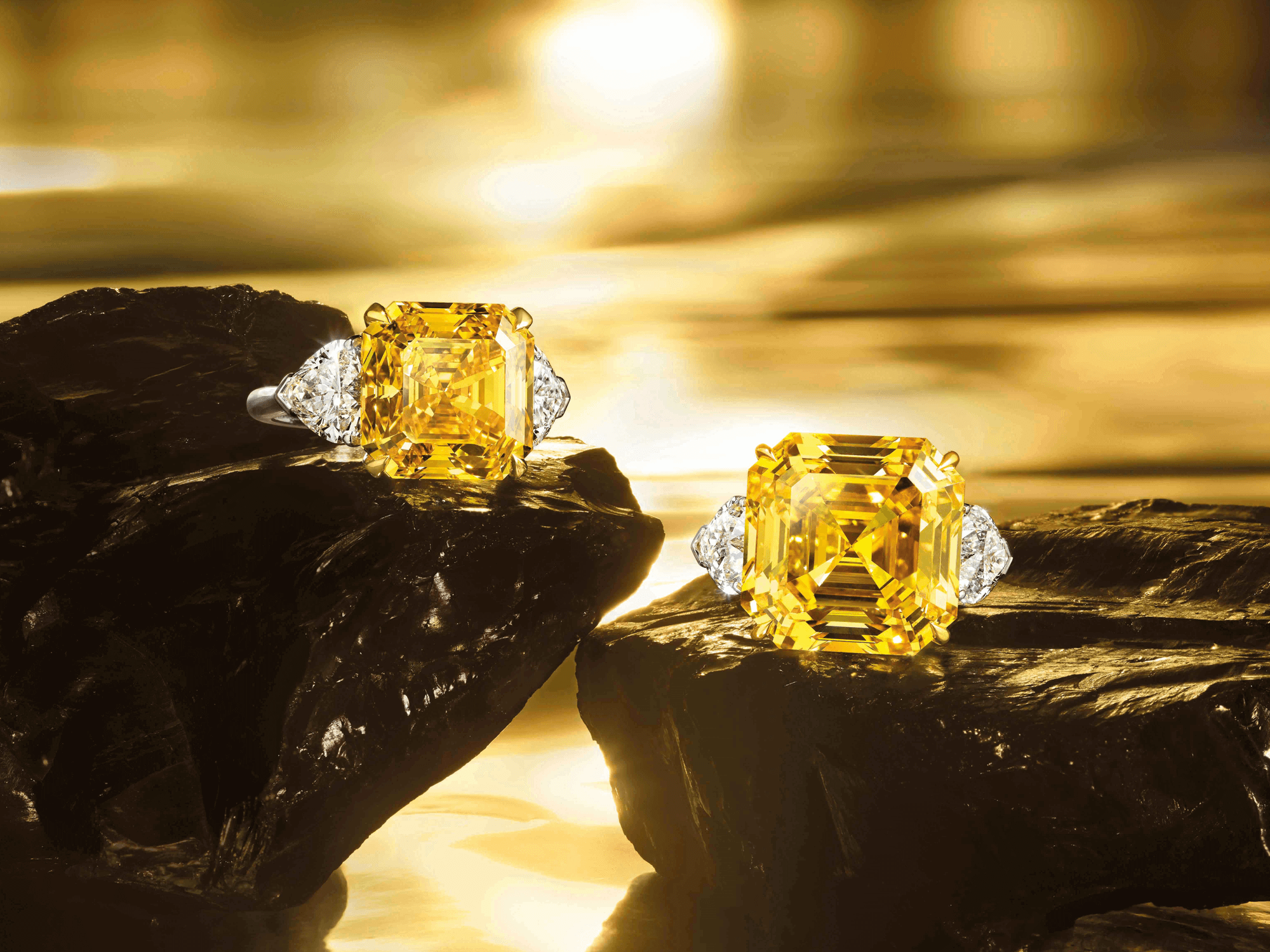 Two Graff Emerald Cut Yellow Diamond Ring set with white diamond shoulder stones