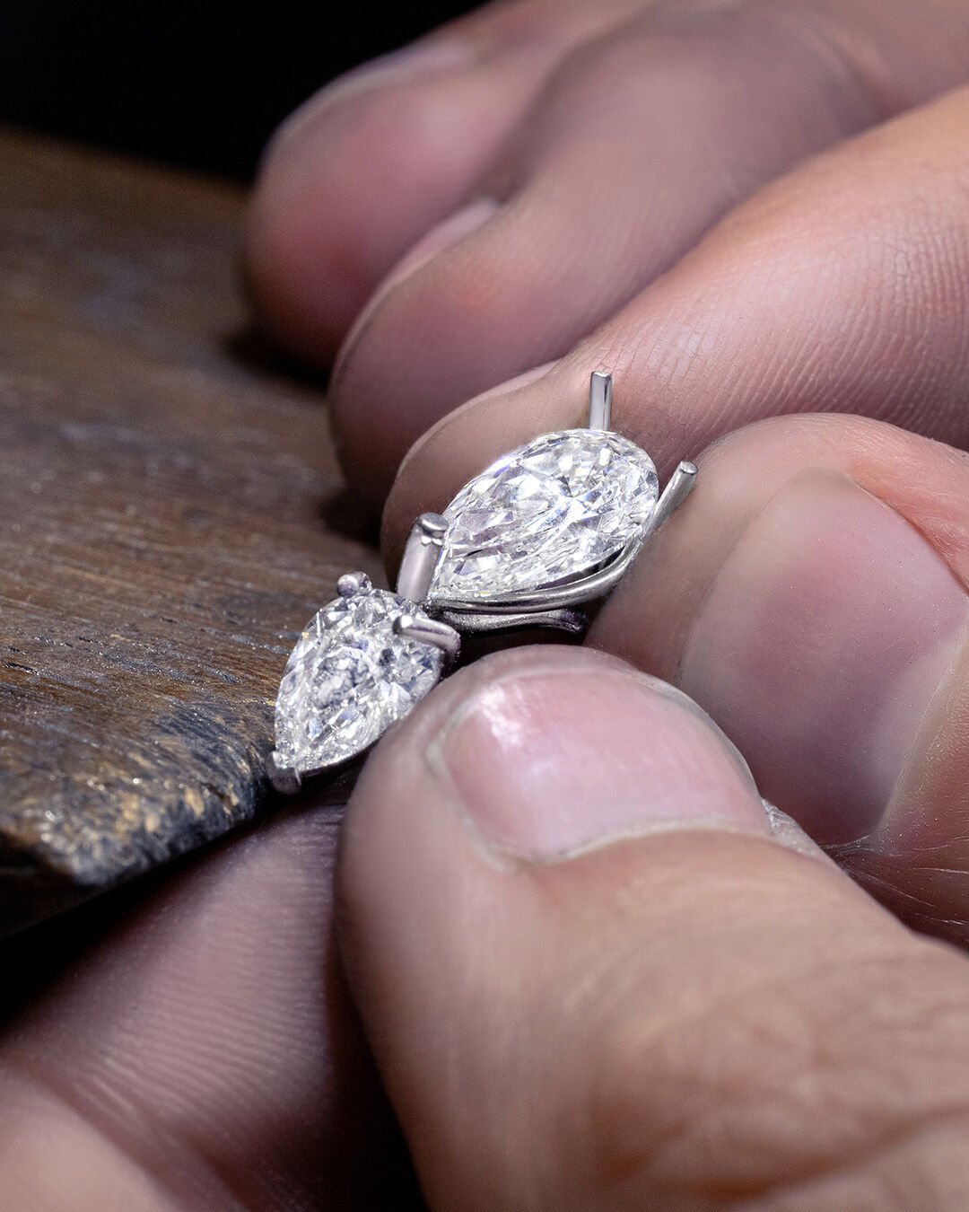 Image shows Graff high jewellery white diamond and emerald earrings being created in Graff workshop
