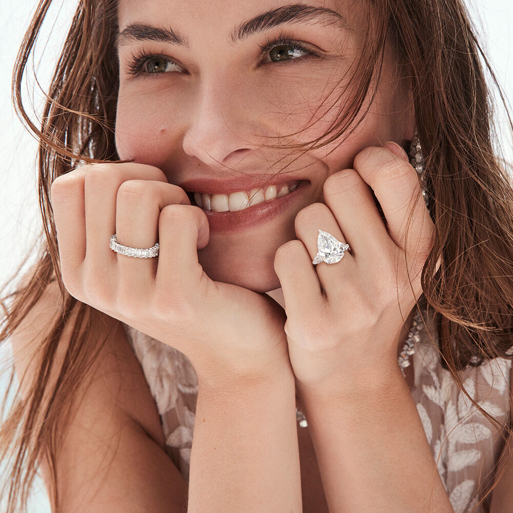 Model wears eternity ring and engagement ring