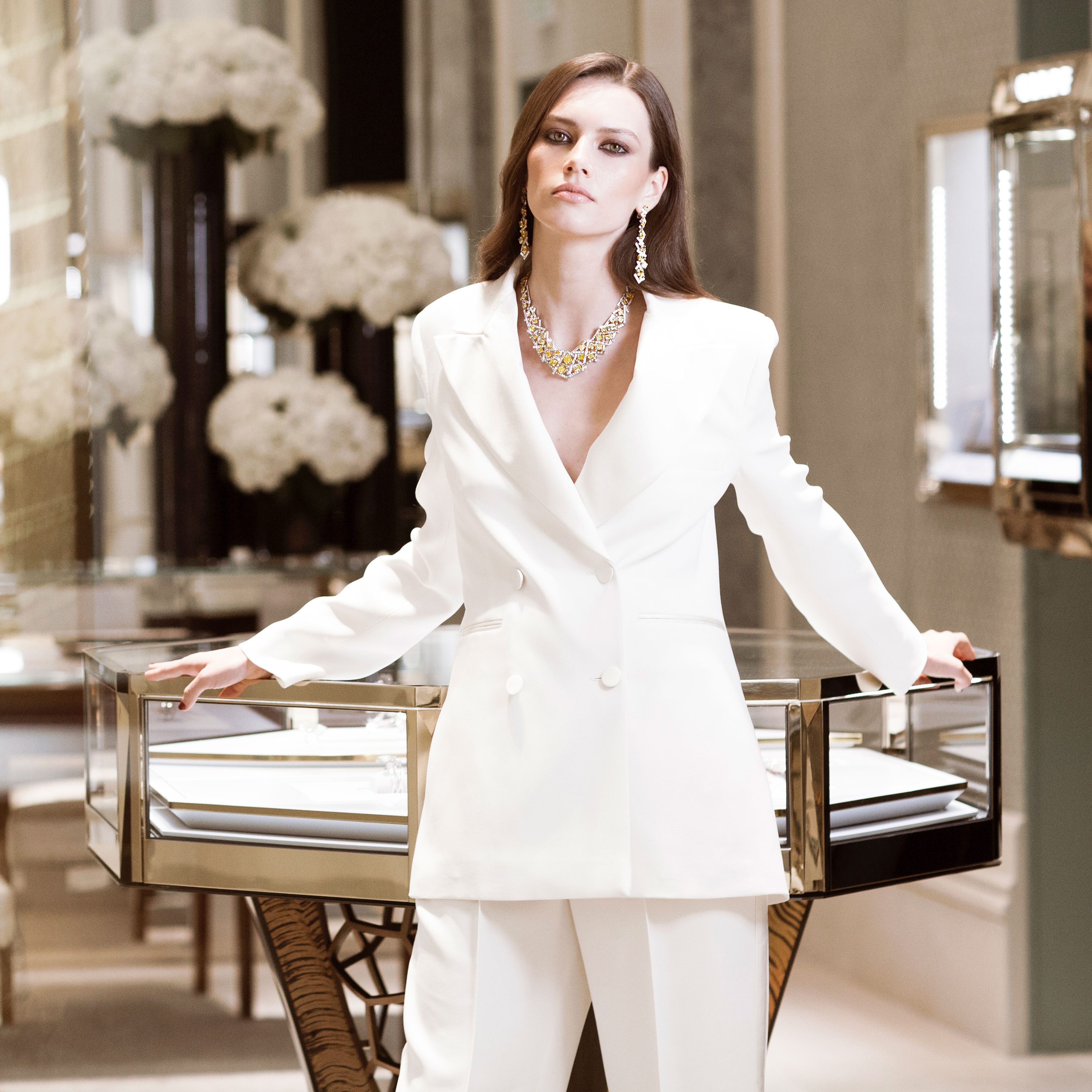 Model wears Graff diamond jewellery in a Graff boutique