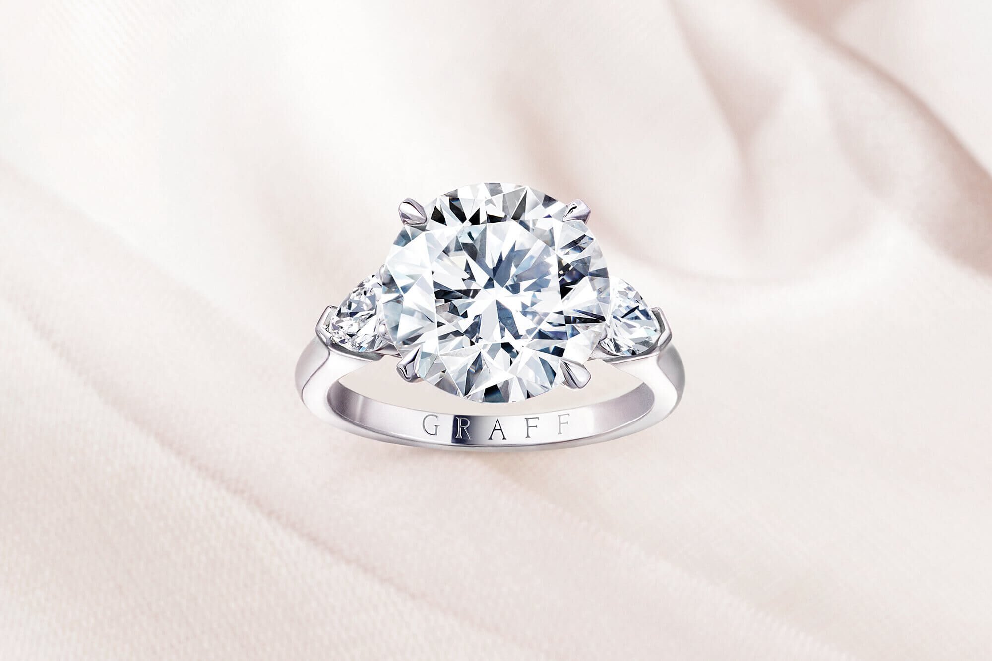 Close up of a Graff Promise round diamond engagement ring 