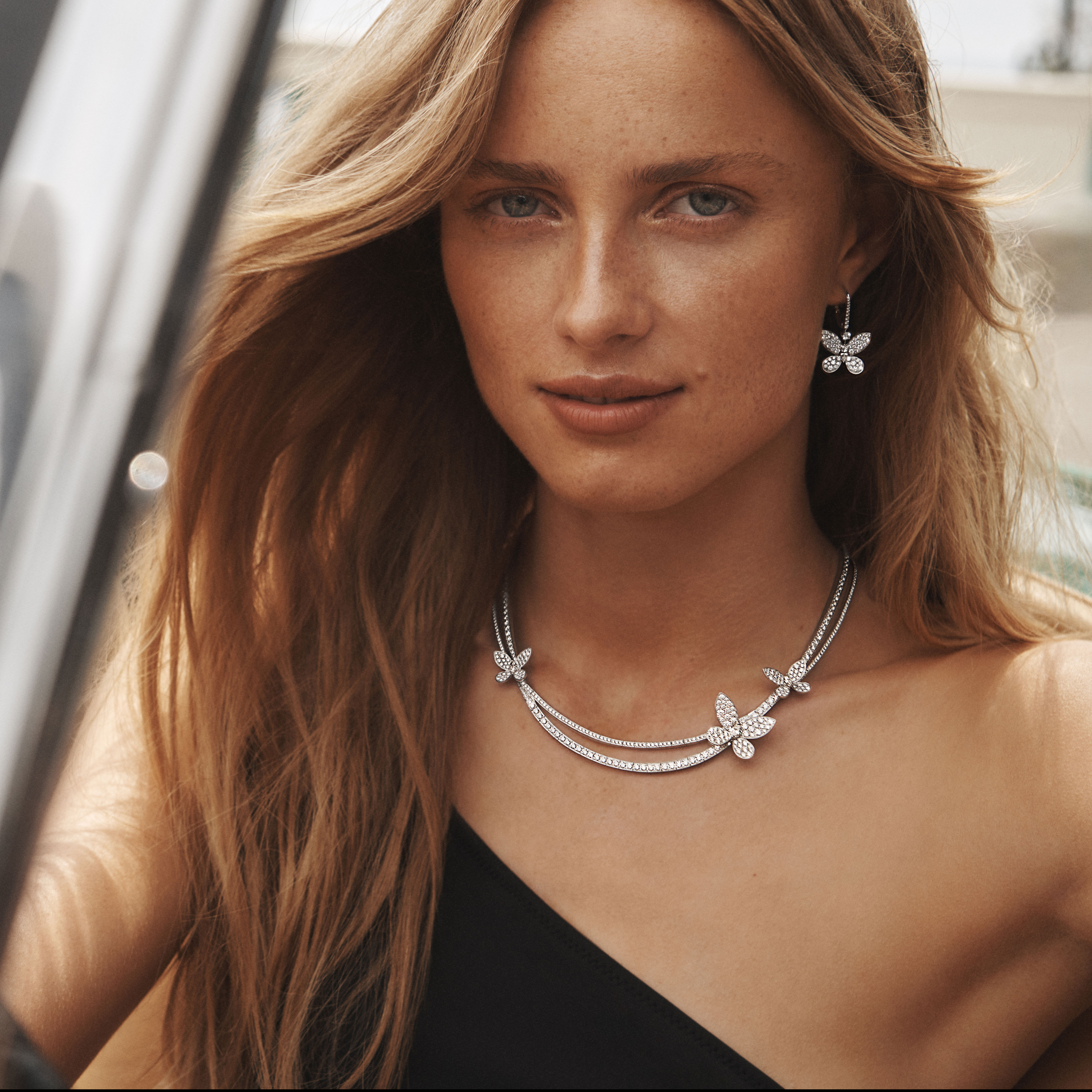 Model wears Graff Tilda's Bow collection white diamond necklace and earrings.