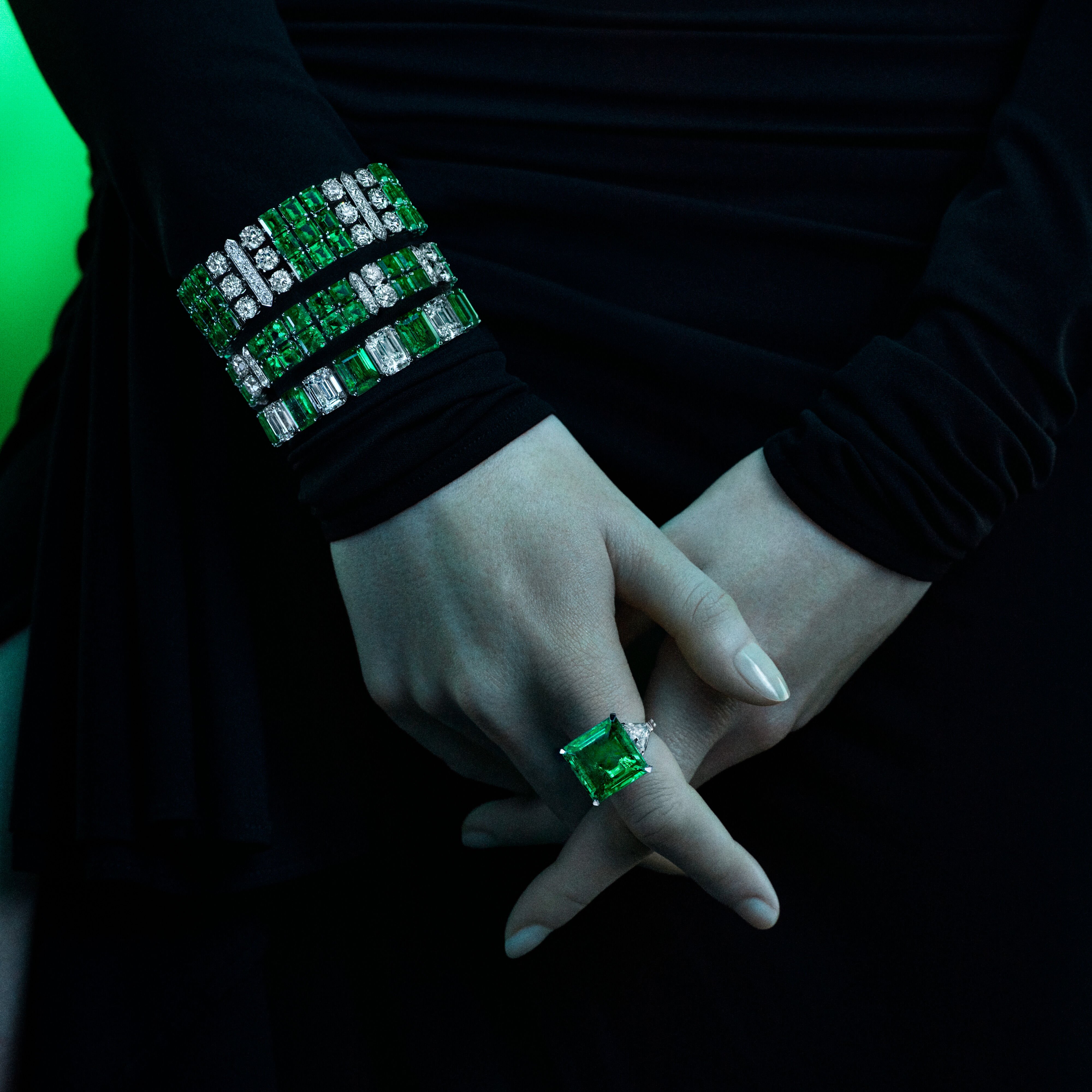 Image of model wearing Graff Galaxia Emerald High Jewellery Bracelets and Ring 