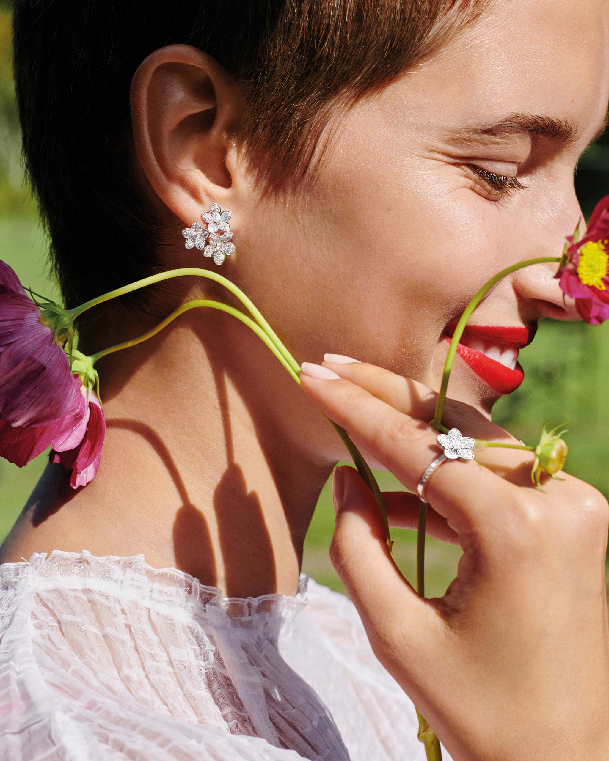 Close up of a model wearing the Graff Wild Flower jewellery collection diamond earrings & ring