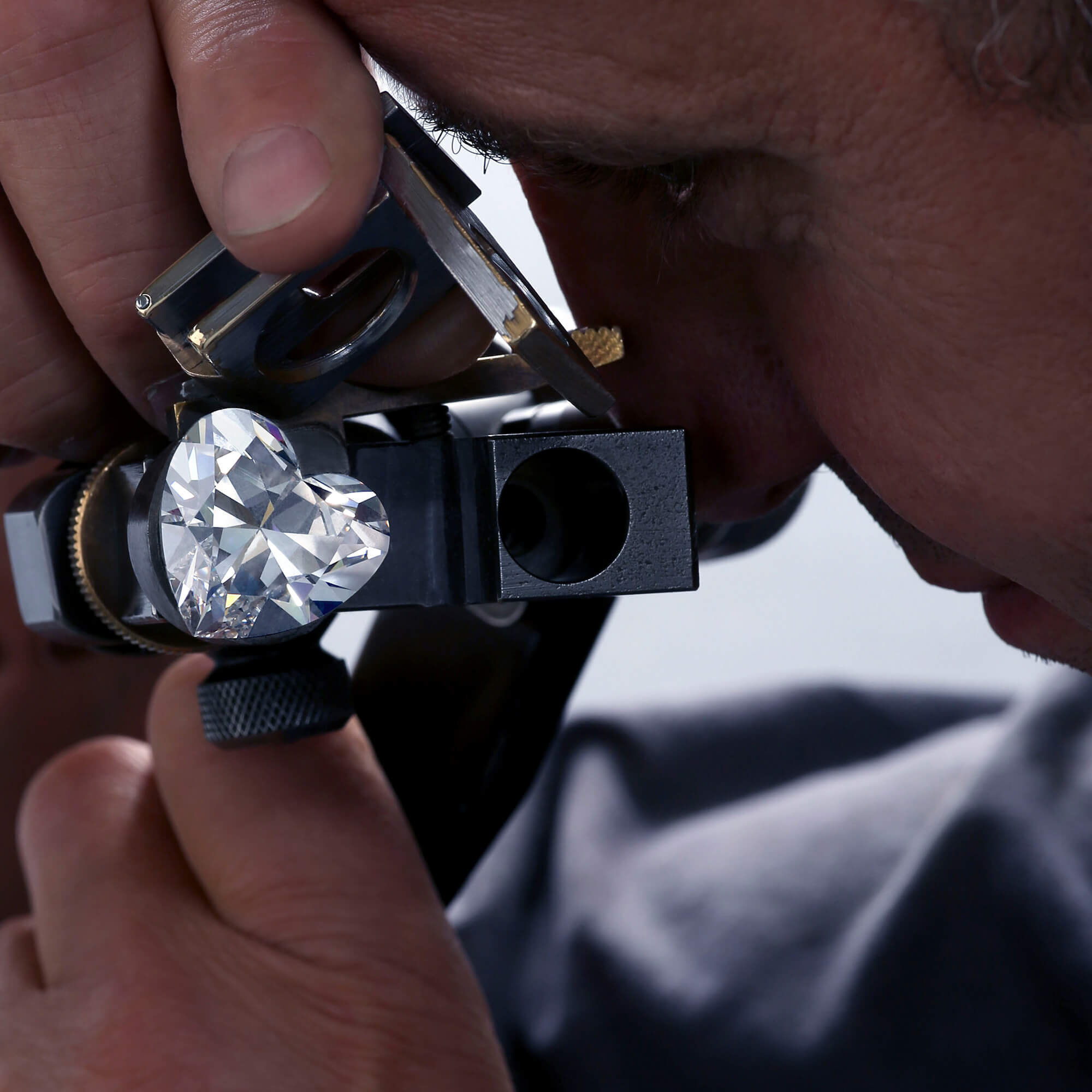 A Graff member looking into the Venus diamond through a loupe