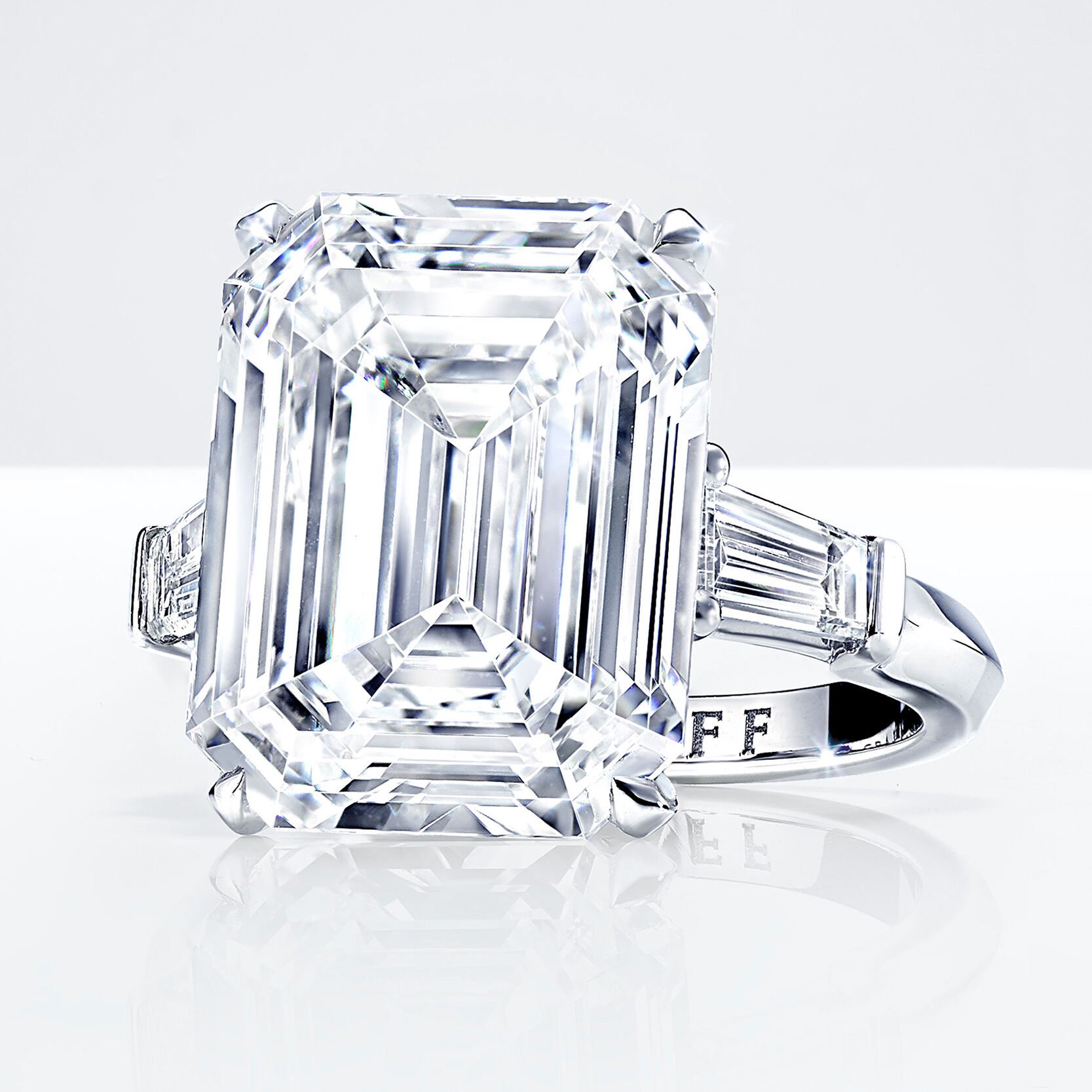 An emerald cut white diamond ring with baguette cut side stones