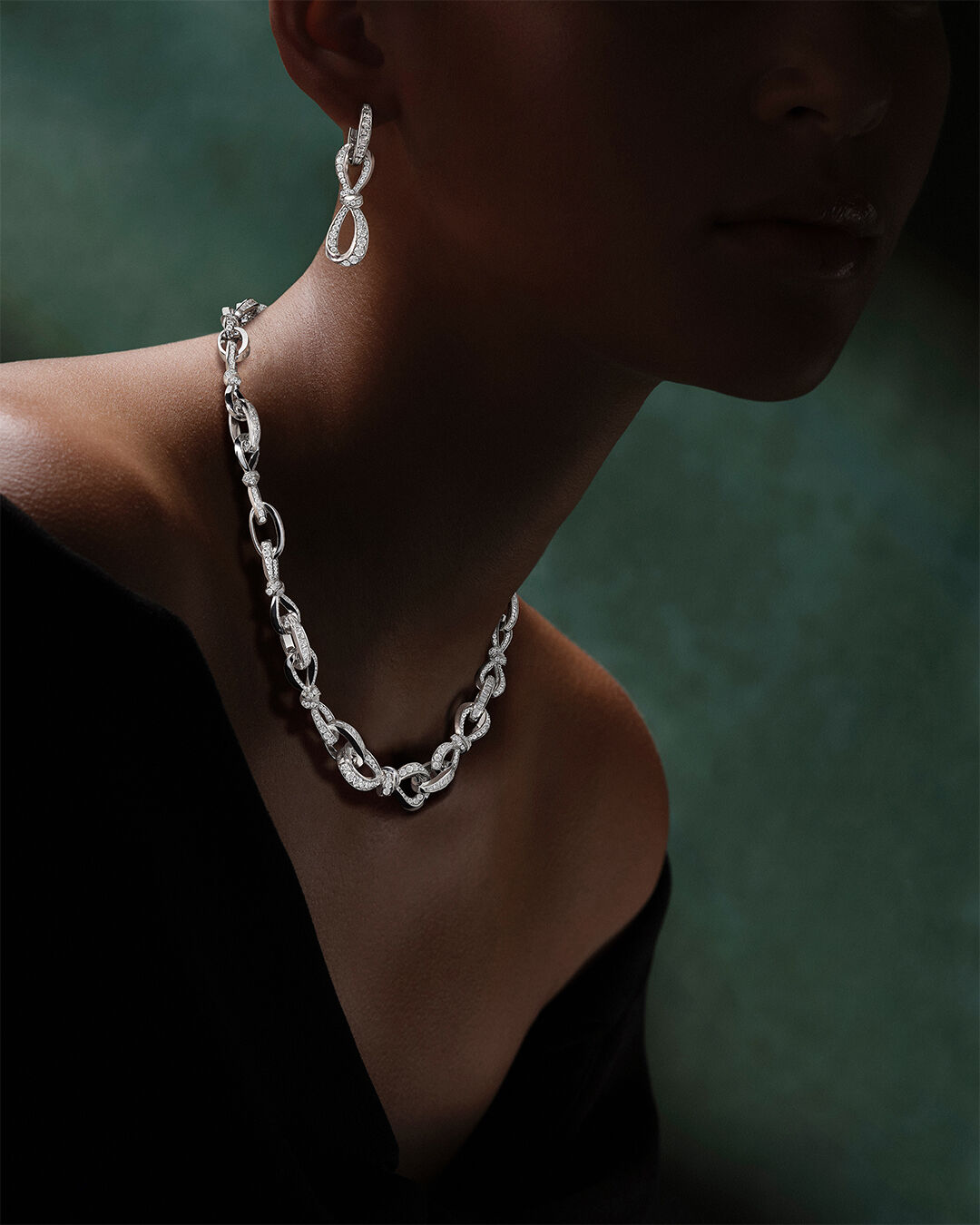 Image shows model wearing Graff Tilda's Bow Necklace and Earrings