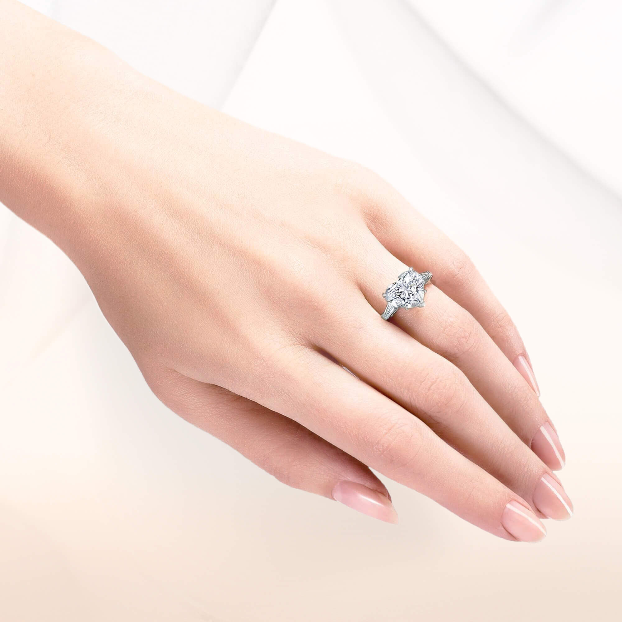 Close up of a Graff heart shape diamond engagement ring wore by a model