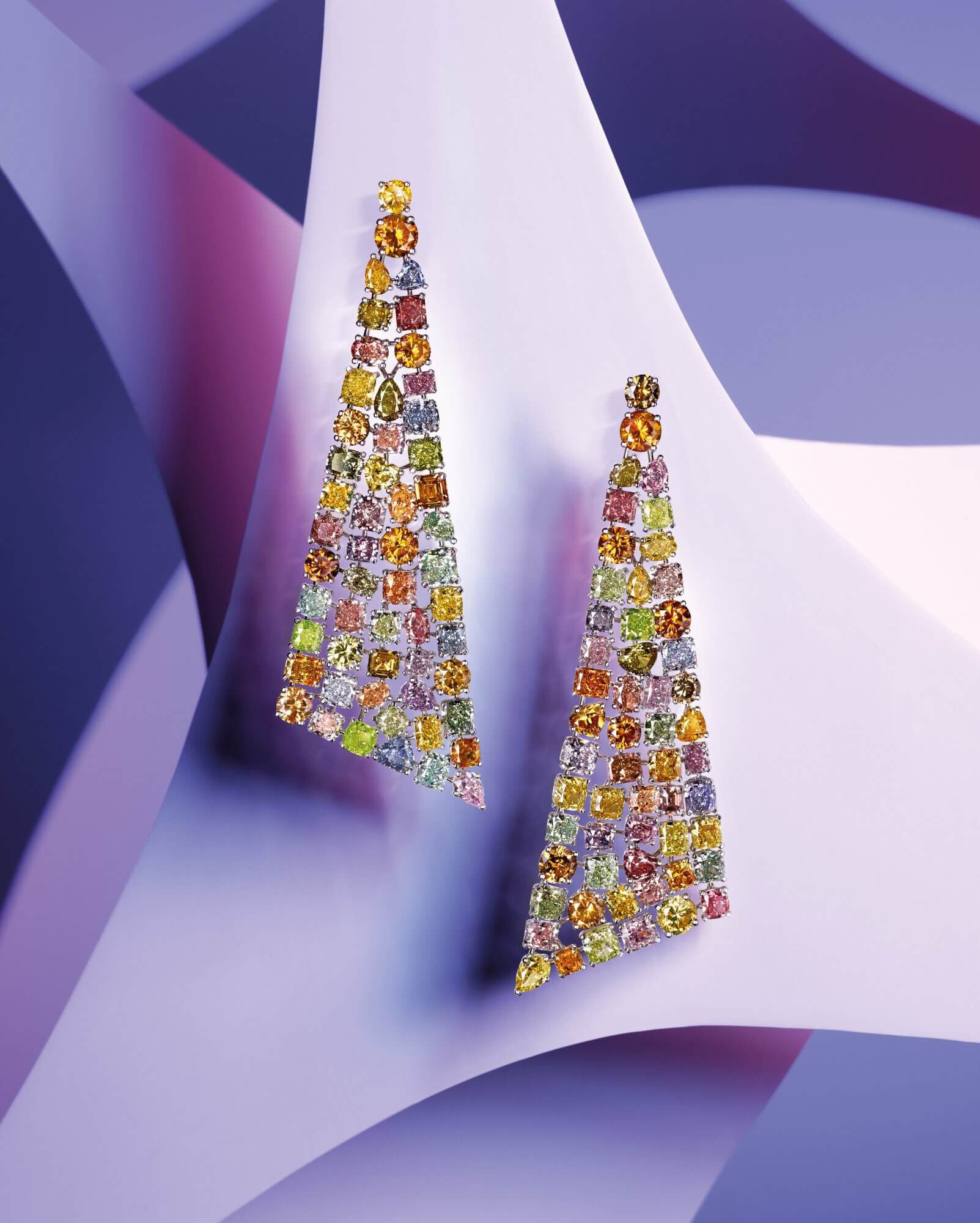 A pair of Graff Multi coloured diamond earrings on purple setting