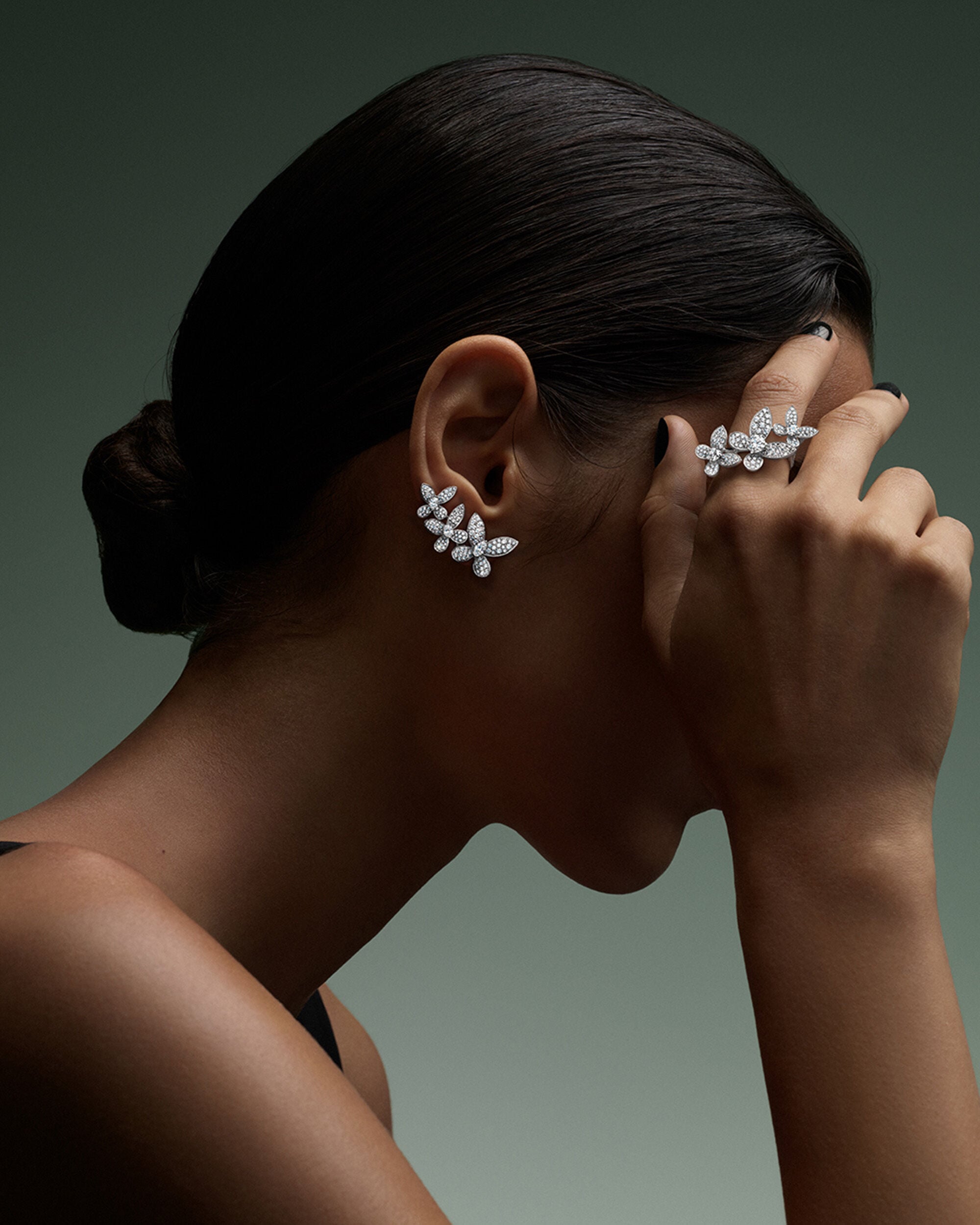 Image shows model wearing Graff Butterfly ring and earrings