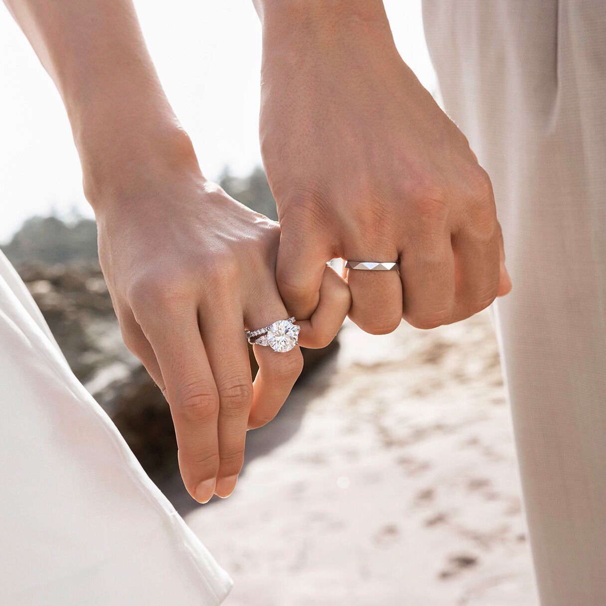 Female and Male model wear Graff Engagement Rings and Wedding Bands