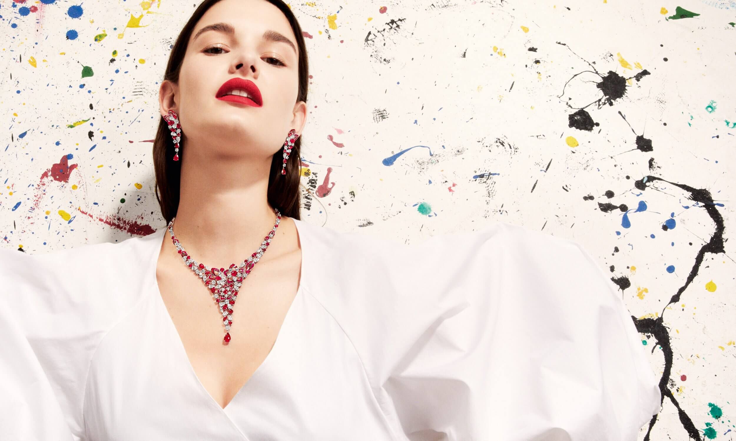 Graff Ruby and Diamond Peony Design necklace by Graff and Ruby and Diamond Peony earrings worn by a model
