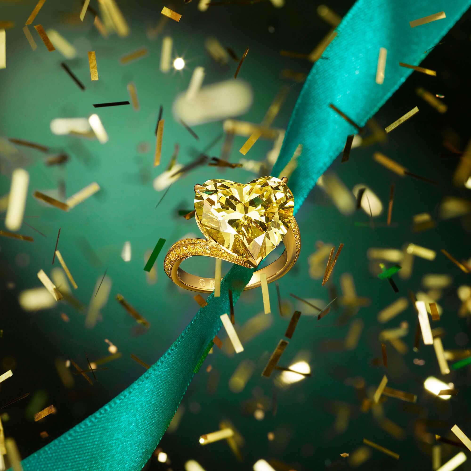 A Graff heart shape yellow diamond ring with ribbon and confetti 