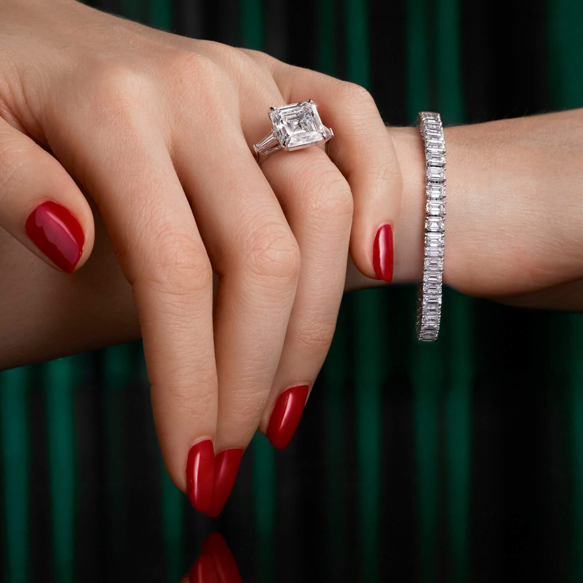 Model wearing a emerald cut diamond bracelet and ring