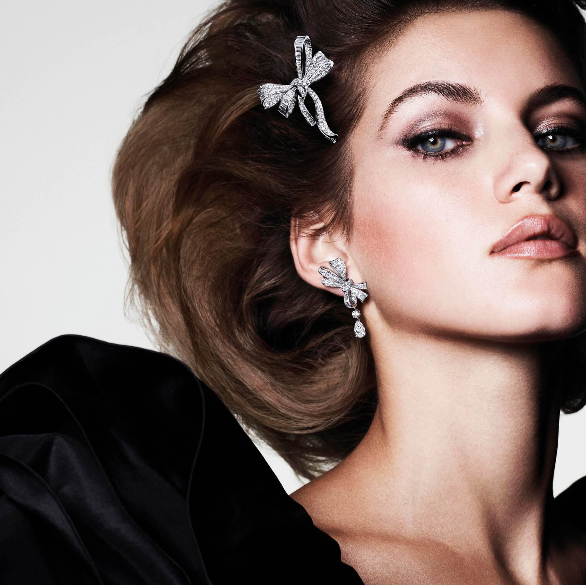 A model wearing Graff Bow collection Diamond brooch and earrings
