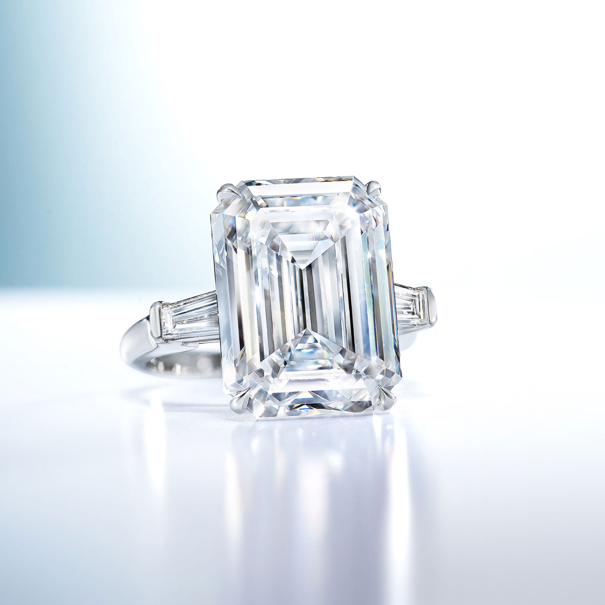 An emerald cut white diamond ring with baguette cut side stones