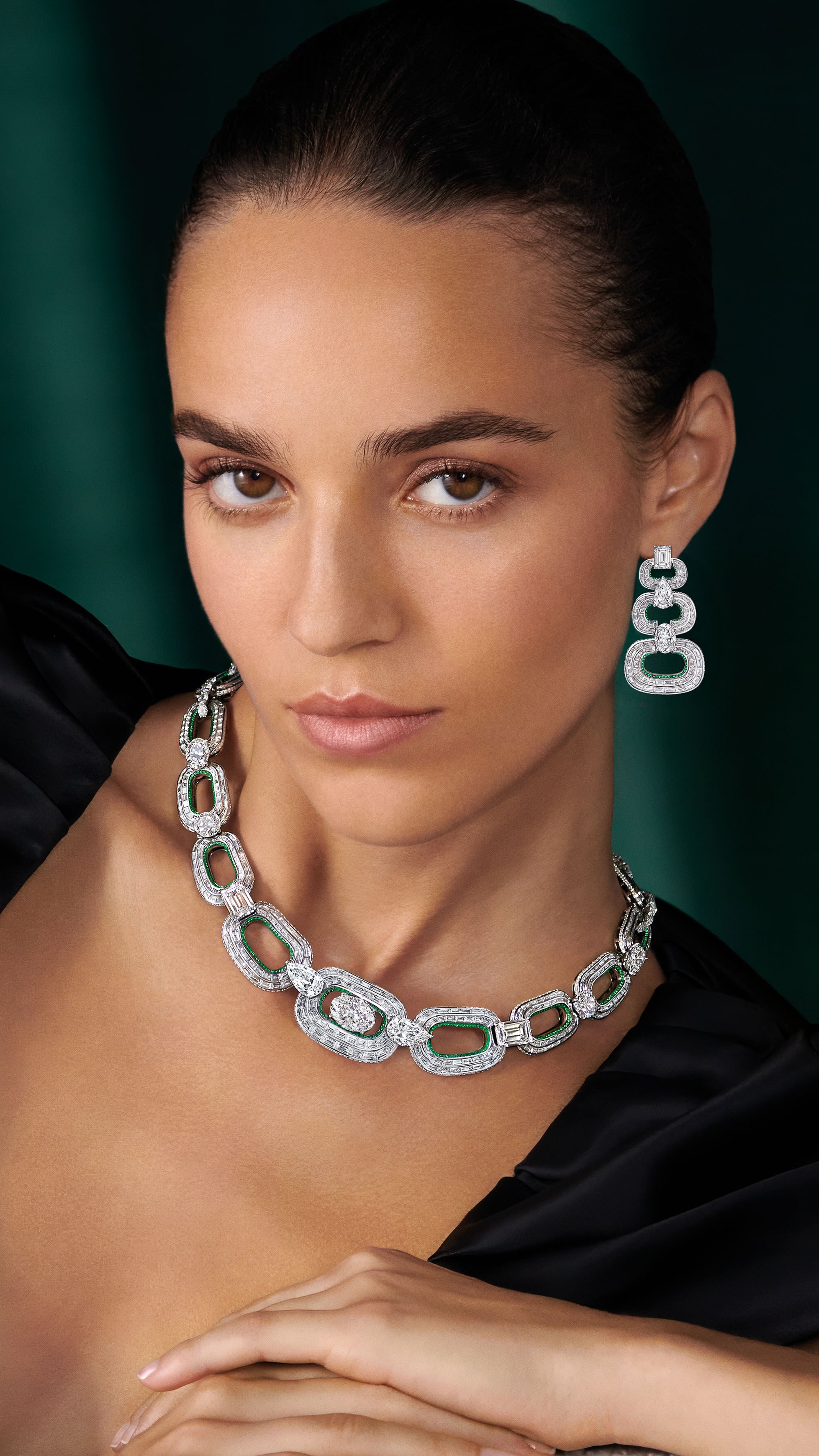 Image shows model wearing Graff White Diamond High Jewellery necklace and earrings