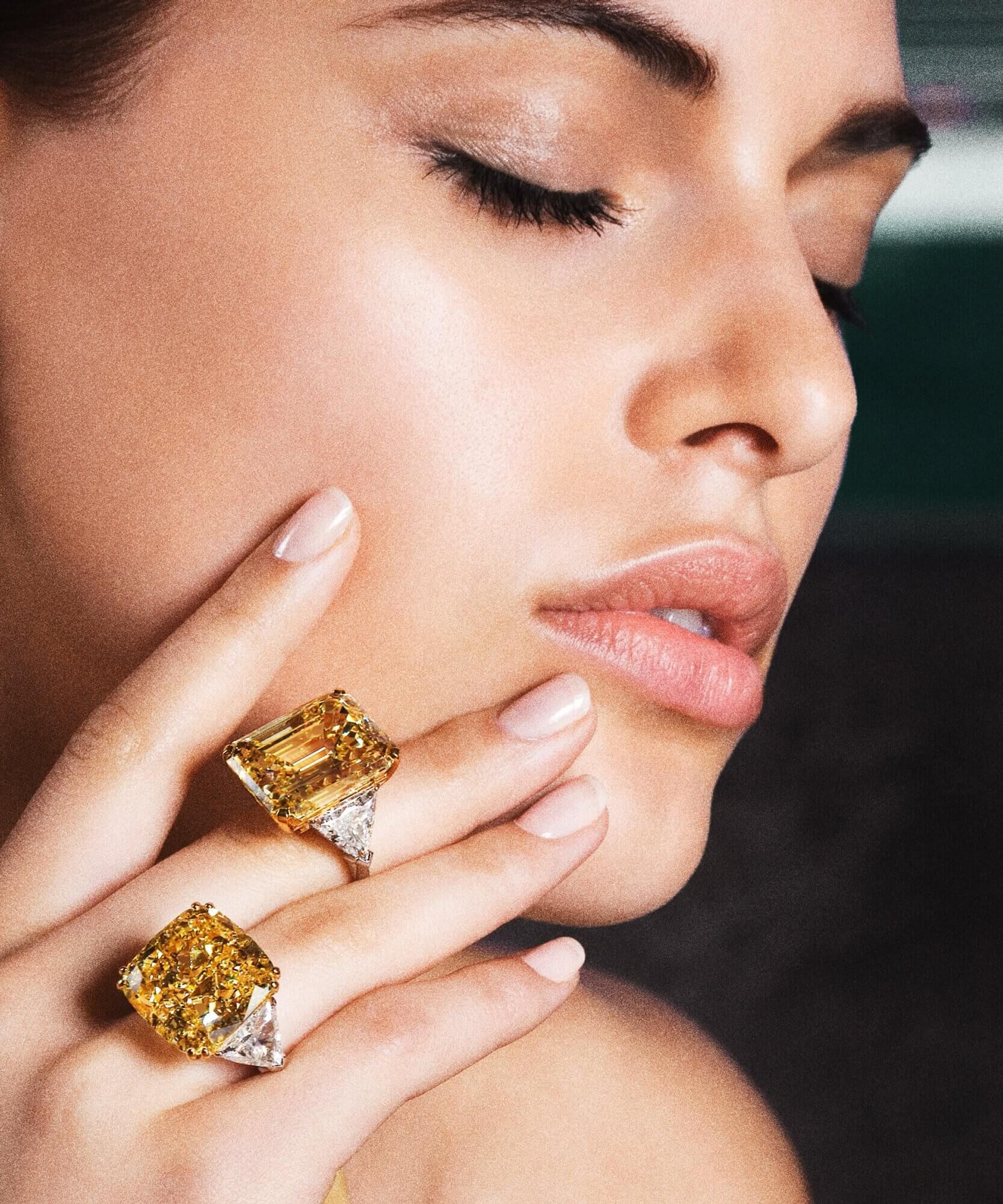 Model wears two yellow diamond rings by Graff