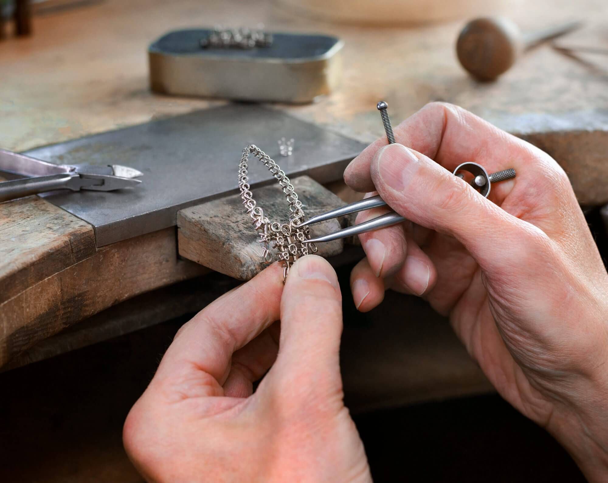 An artisan working on articulations within the earring setting
