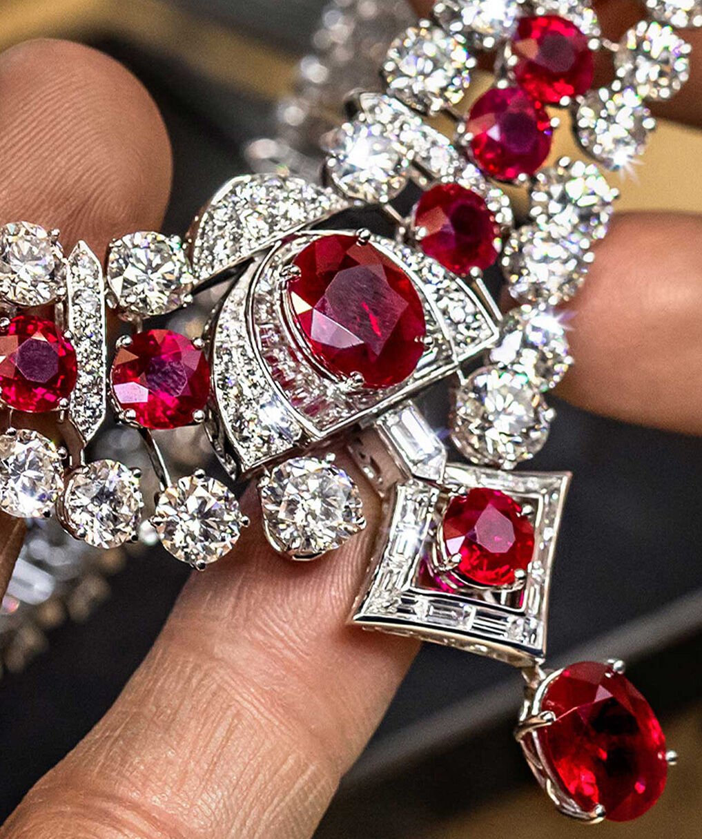 Craftsman holding Graff ruby and white diamond high jewellery necklace in Graff workshop