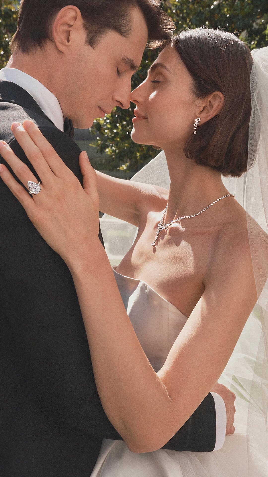 Image shows model wearing Graff oval diamond jewellery and icon oval engagement ring