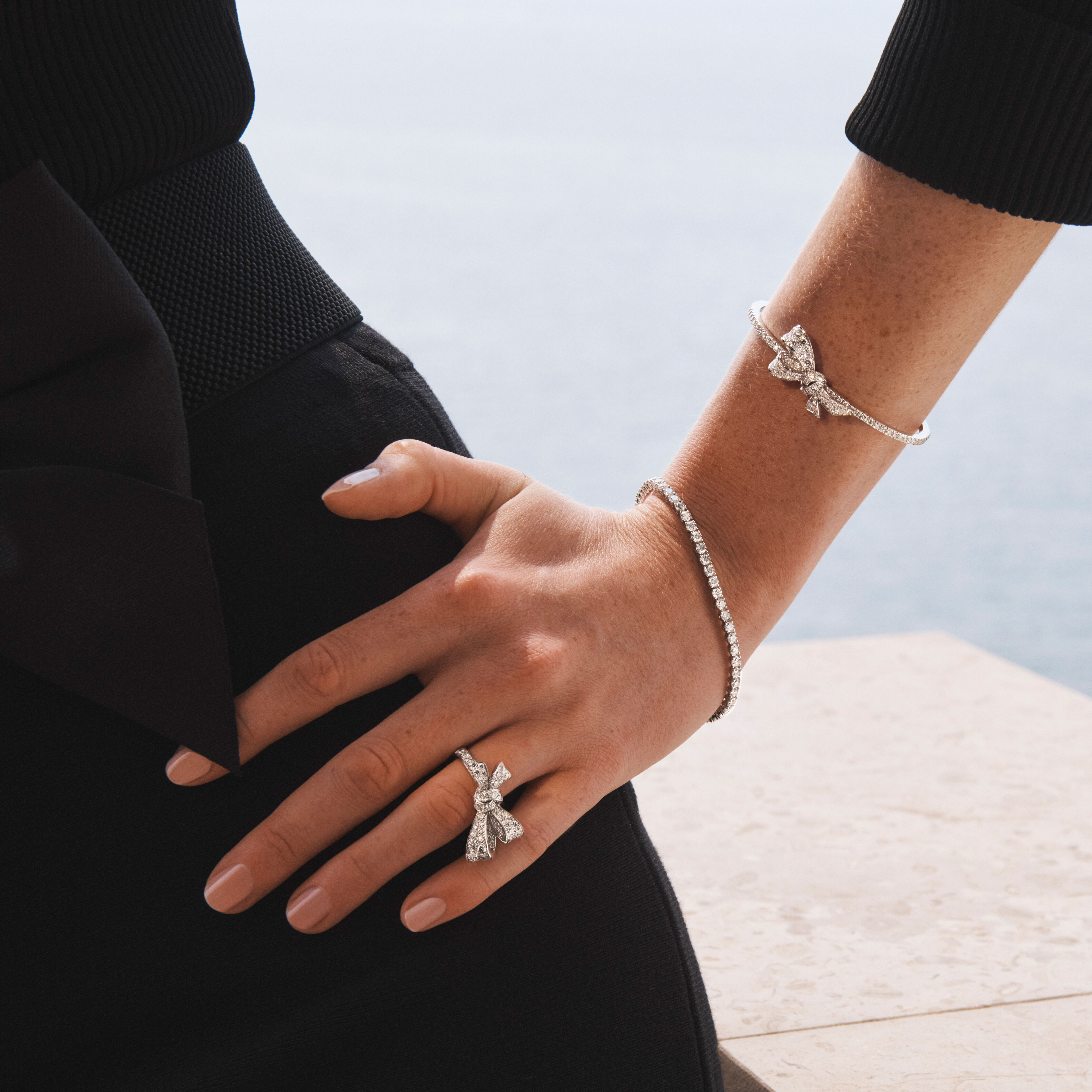 Model wears Graff Tilda's Bow collection white diamond ring and bracelet.
