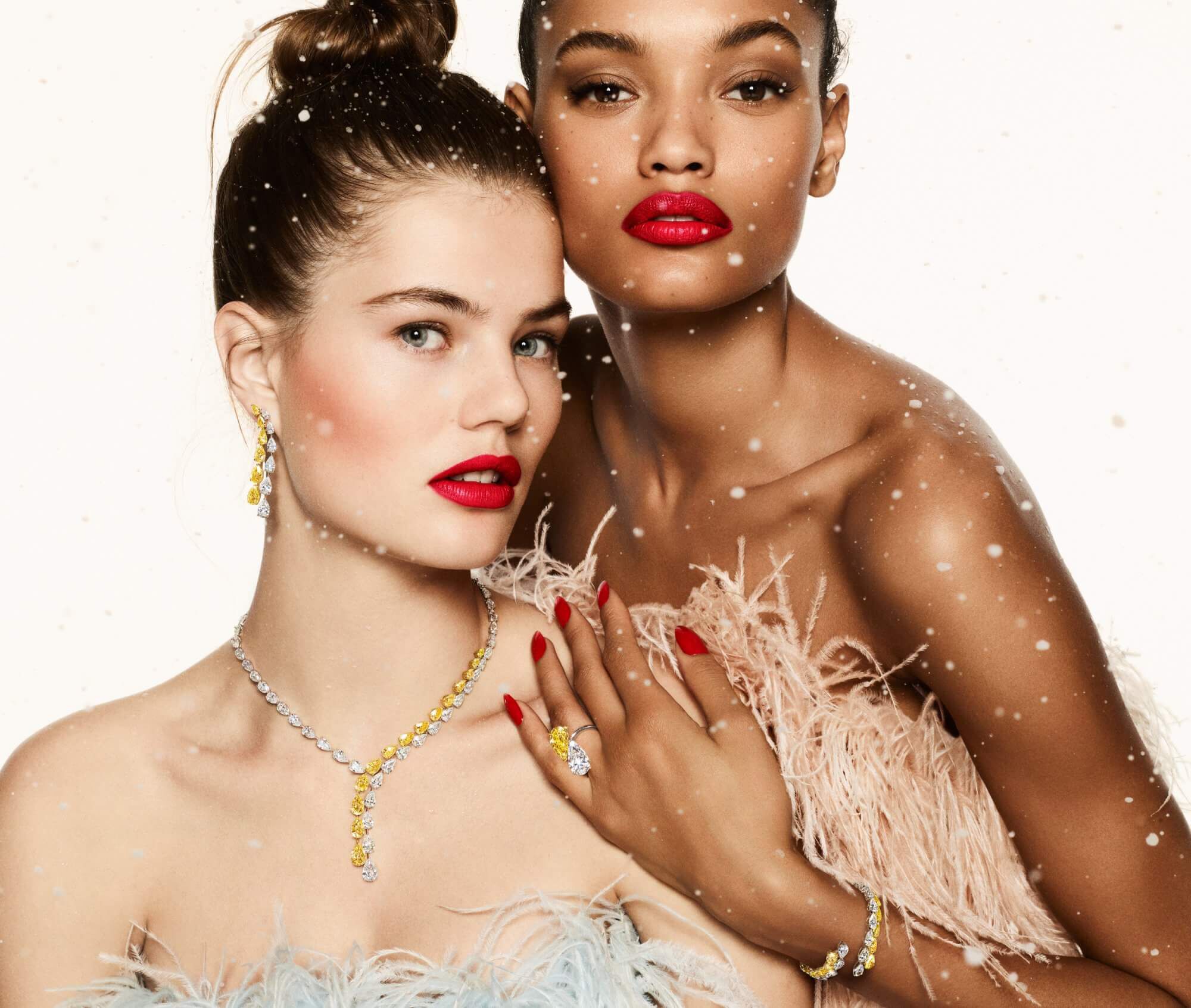 Two models wearing Graff white and yellow diamond high jewellery