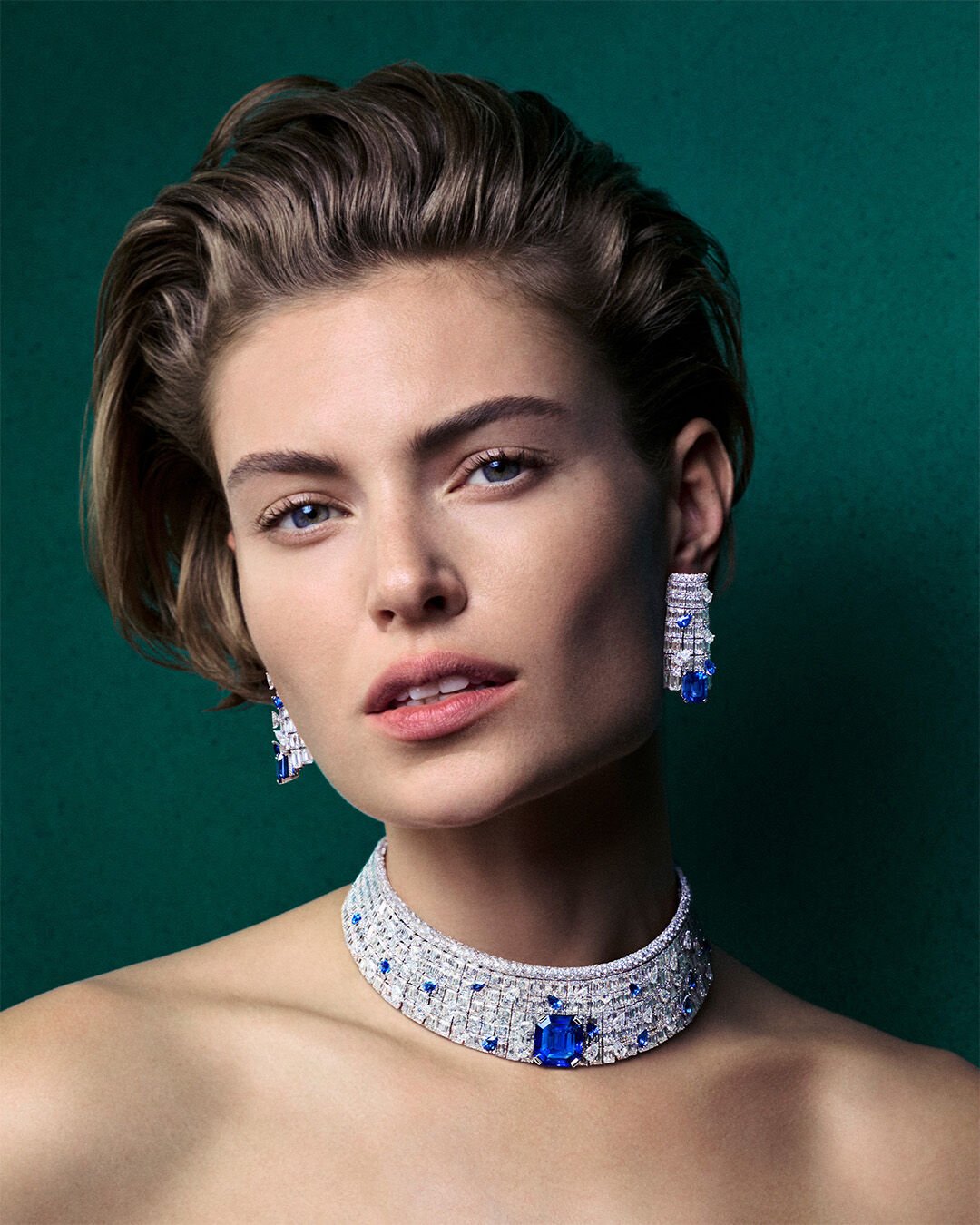 Image shows model wearing Graff Sapphire and White Diamond High Jewellery Necklace and Earrings