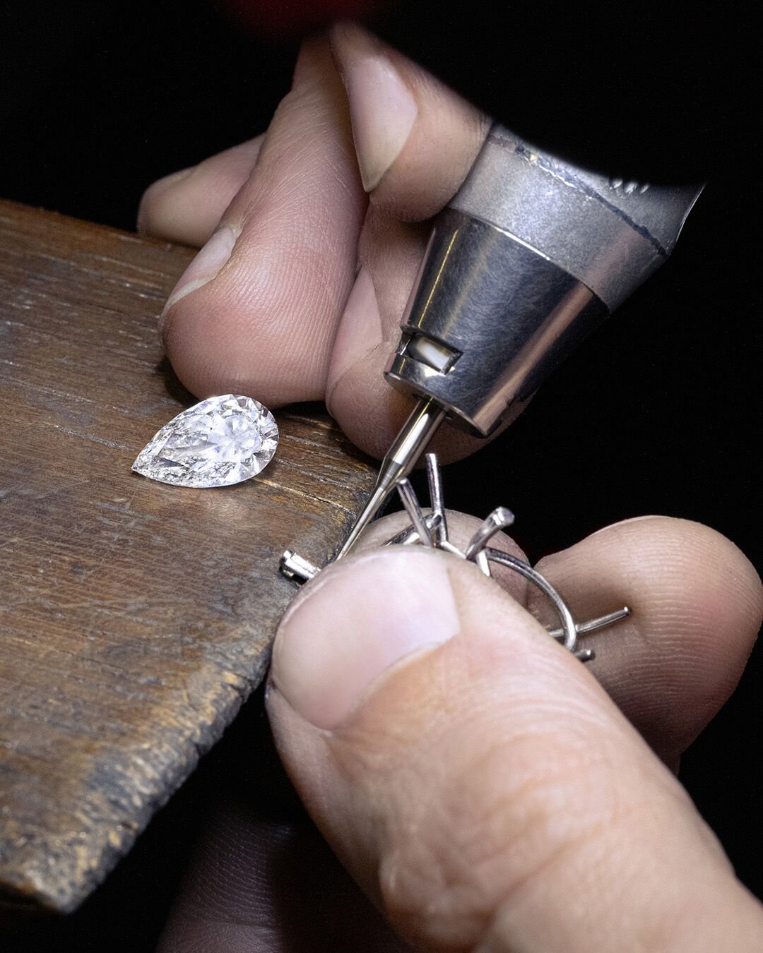 Image shows Graff high jewellery white diamond and emerald earrings being created in Graff workshop