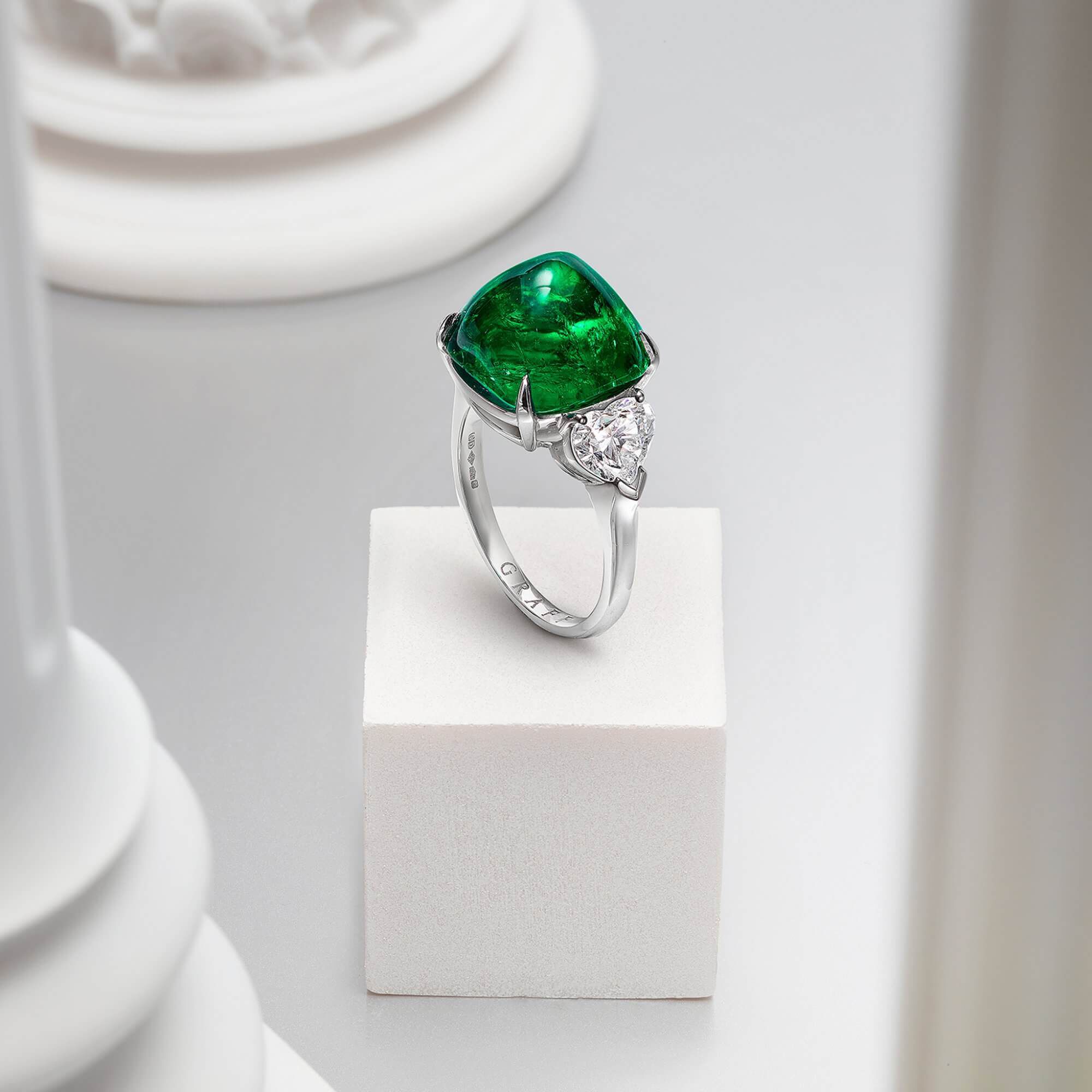 Graff Cabochon Emerald Promise High Jewellery Ring With White Heart Shape Diamond Shoulders inside a Gallery.