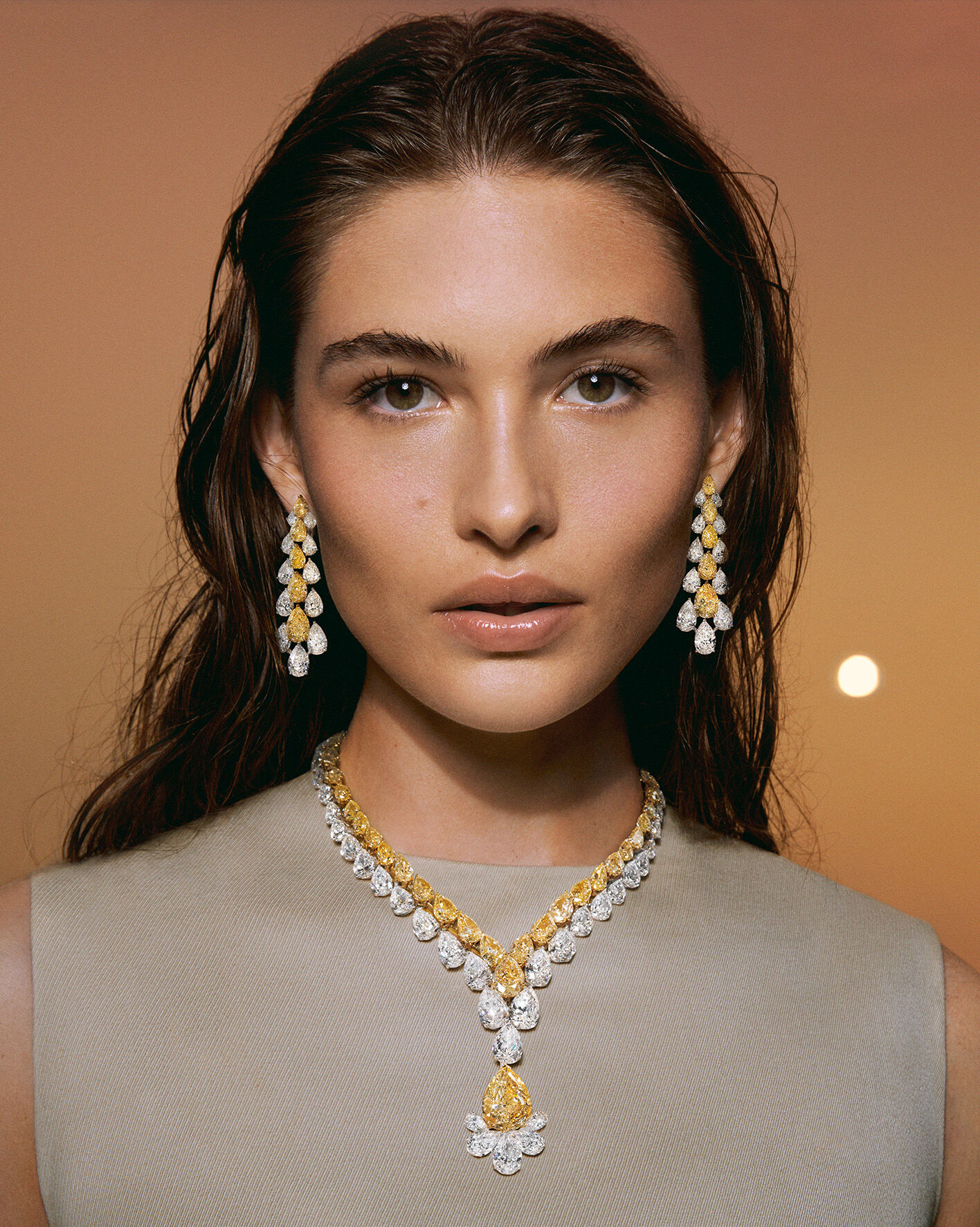 Models wearing Yellow and Diamond Graff High Jewellery suites on beach 