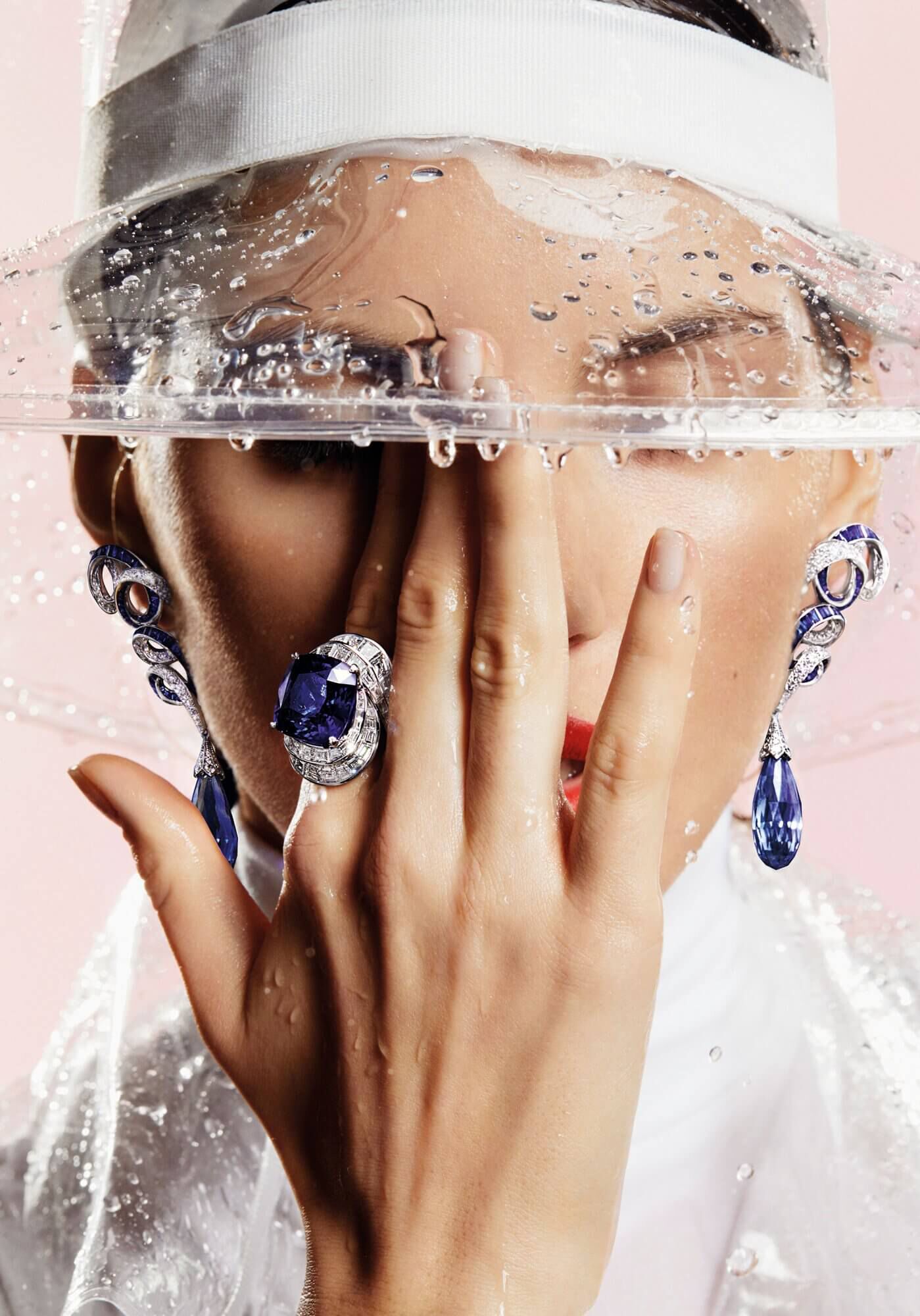 Close up of a model wearing a Graff Sapphire and Diamond Ring and a pair of Inspired by Twombly Collection Diamond Earrings 