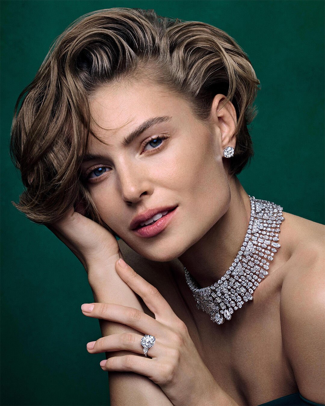 Image shows model wearing Graff White Diamond High Jewellery necklace, earrings and ring