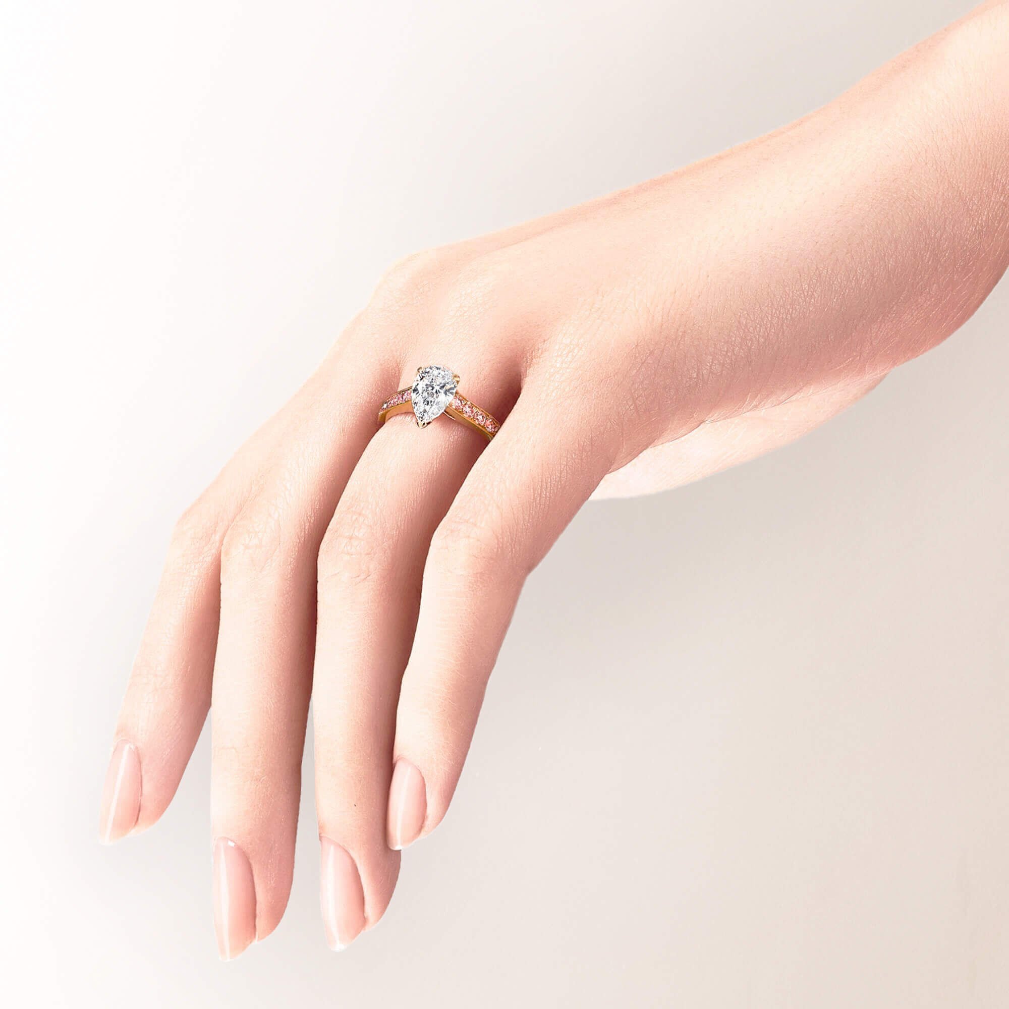 A models hand wearing a Graff pear shape diamond engagement ring