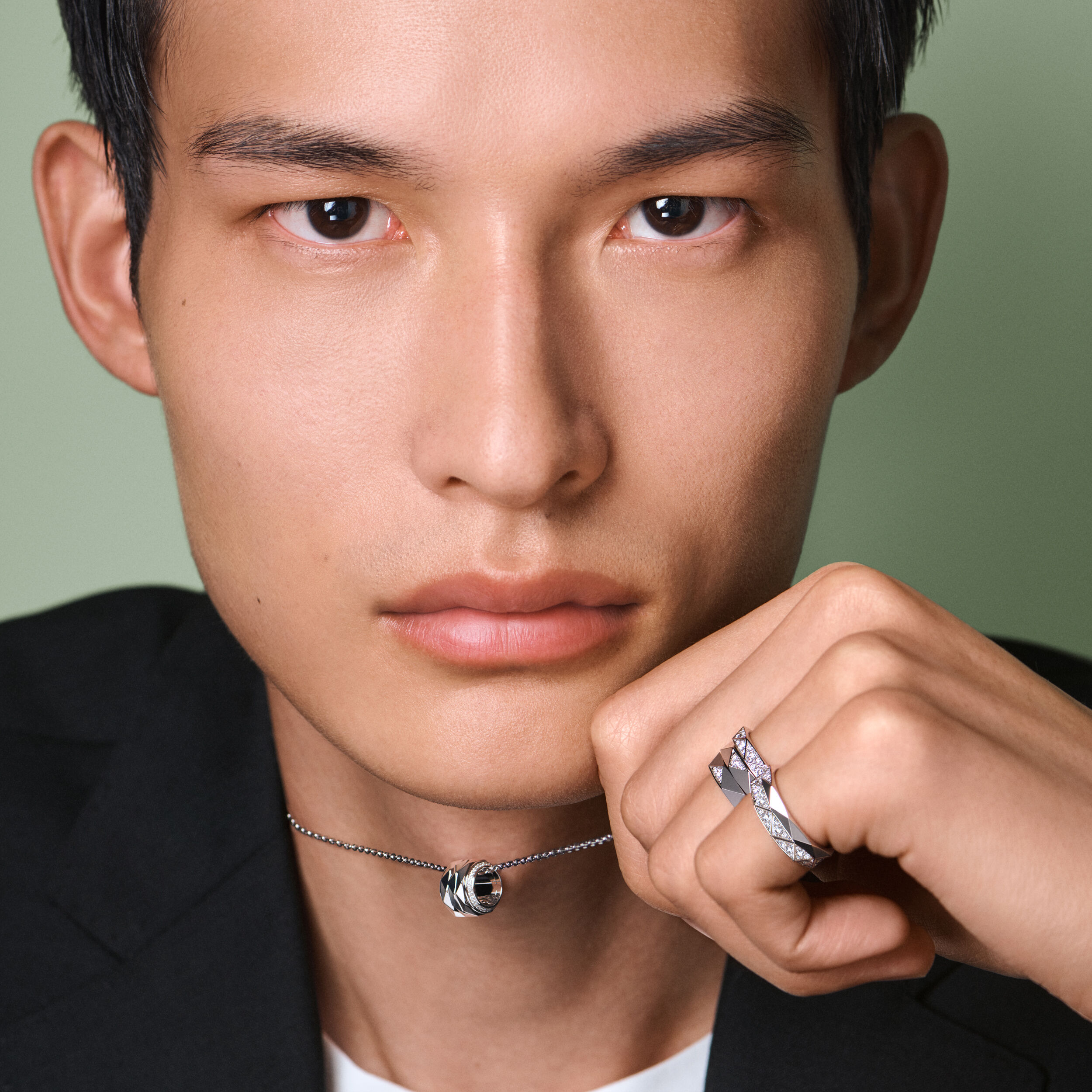 Male model wears Laurence Graff Signature pendant and rings 