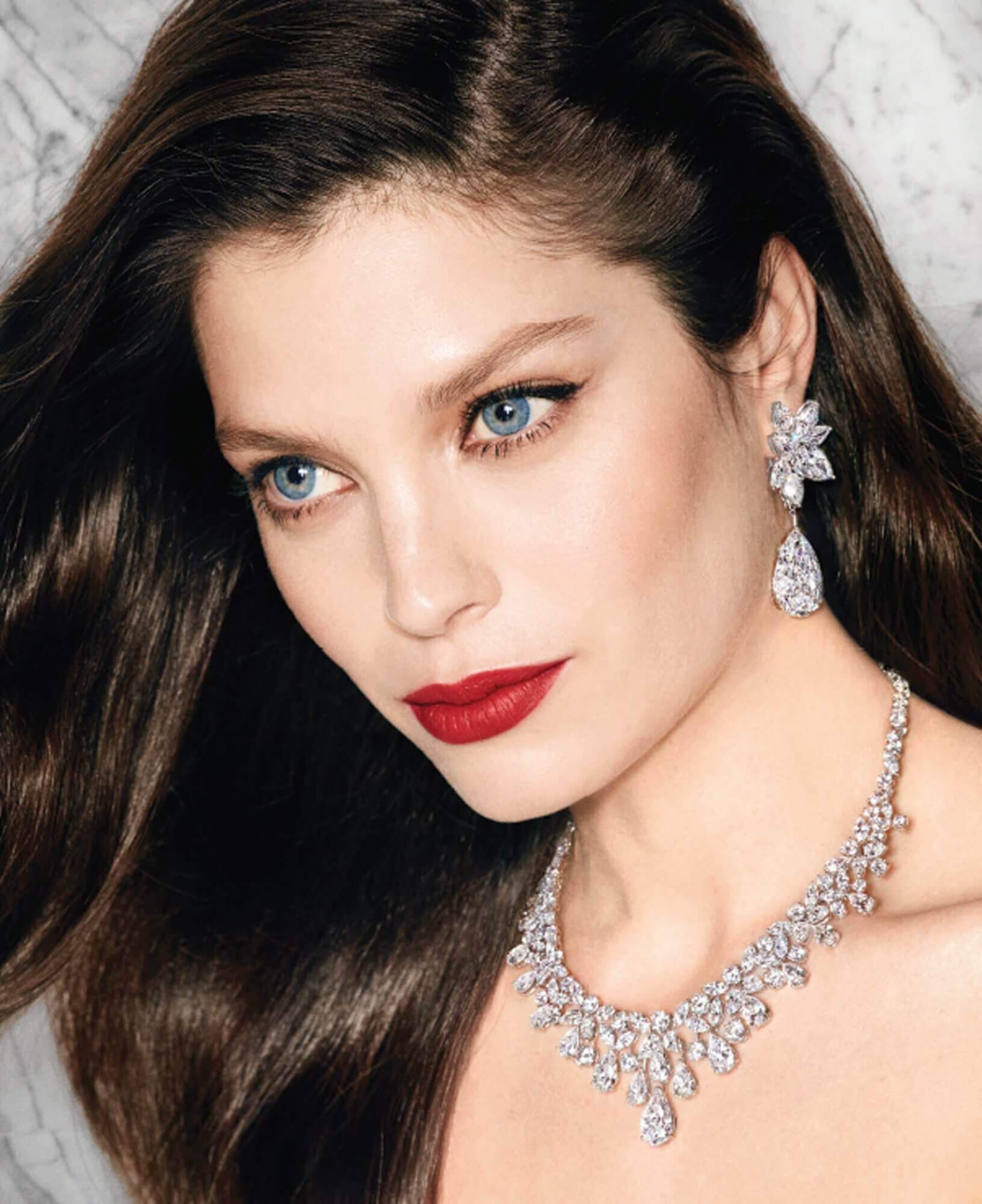 Model wears Graff Diamonds Diamond earrings featuring two 20 carat D Internally Flawless pear shape diamond drops