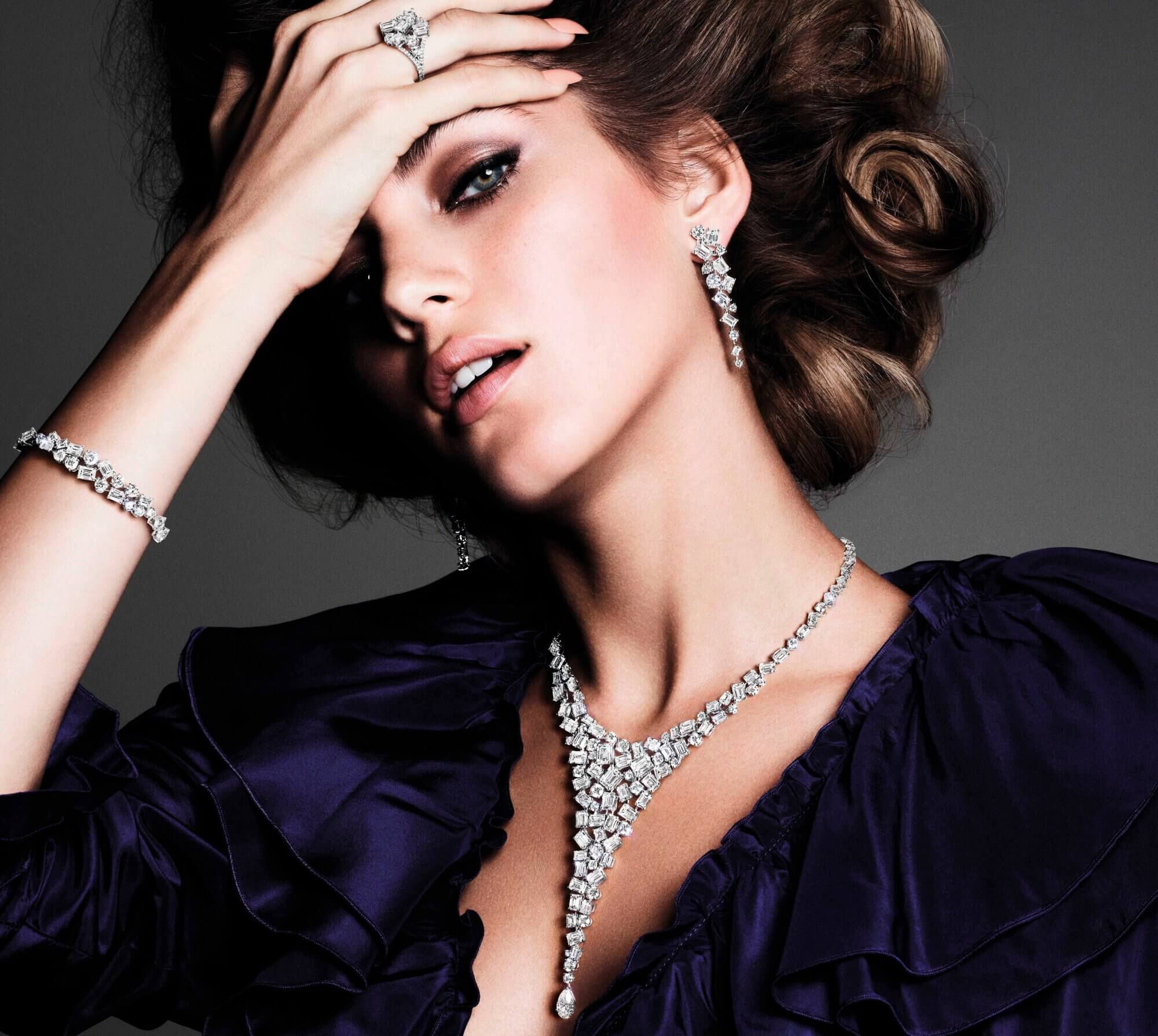 A model wearing Graff Abstract collection Diamond earrings ring bracelet and necklace