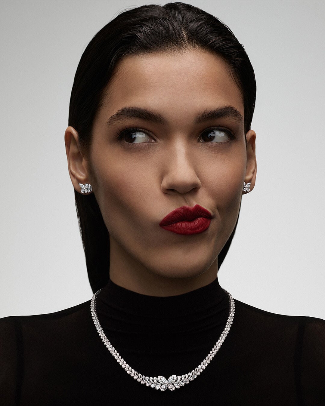 Image shows model wearing Graff Butterfly Earrings and Necklace