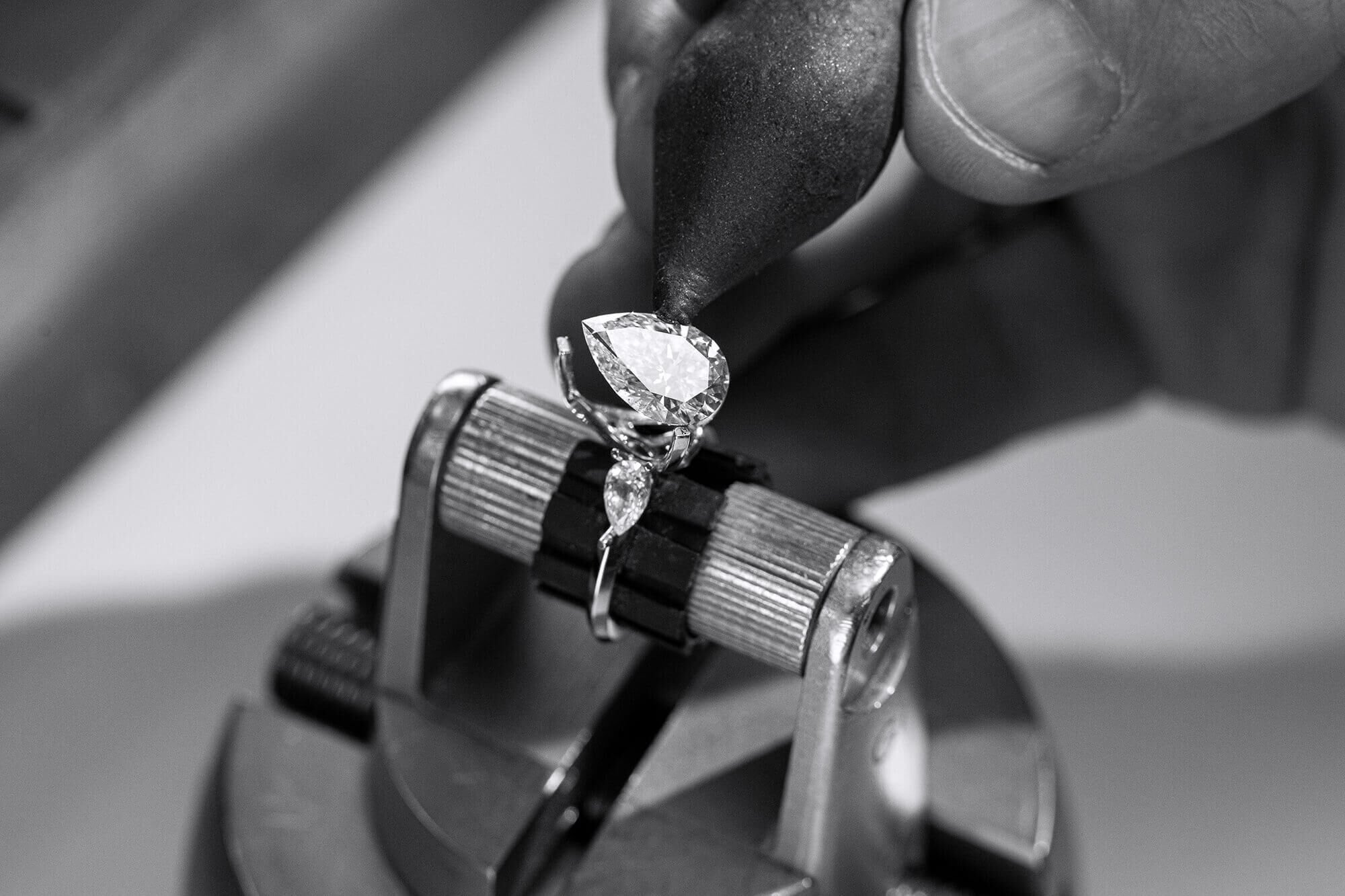 Close up of a Graff craftsman setting a diamond engagement ring 
