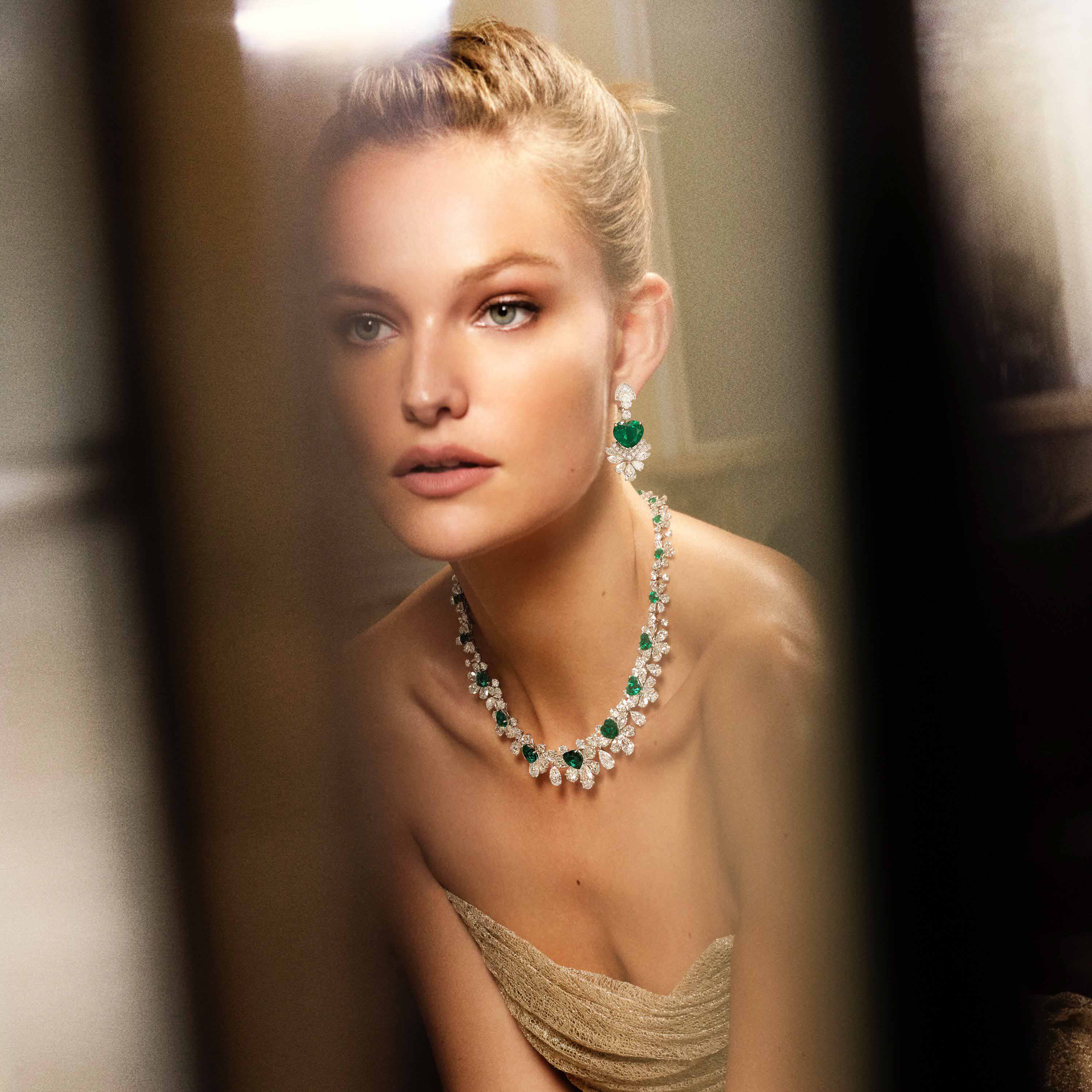 Model wears Graff emerald and white diamond high jewellery 