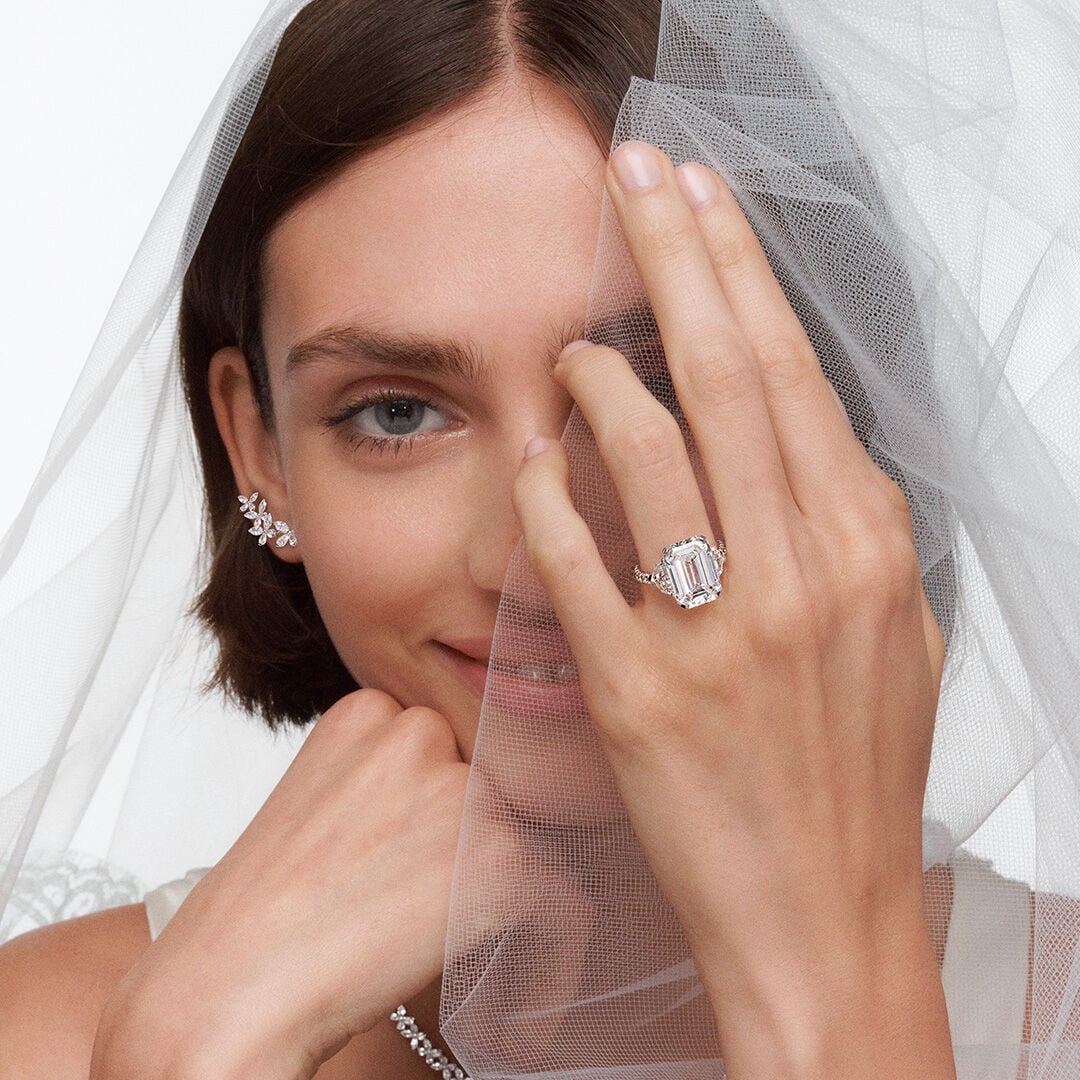 Image of model wearing Graff Promise Emerald Cut Engagement ring and Graff Butterfly Earrings and Necklace