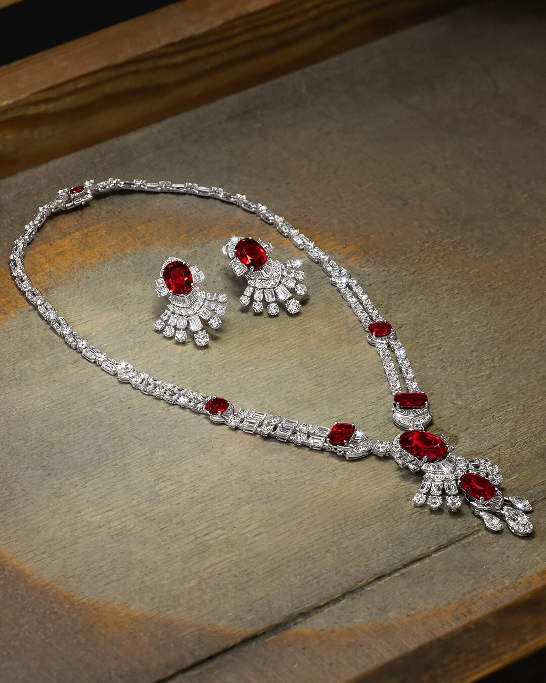 Image shows Graff Ruby High Jewellery necklace and earrings being created in Graff workshop