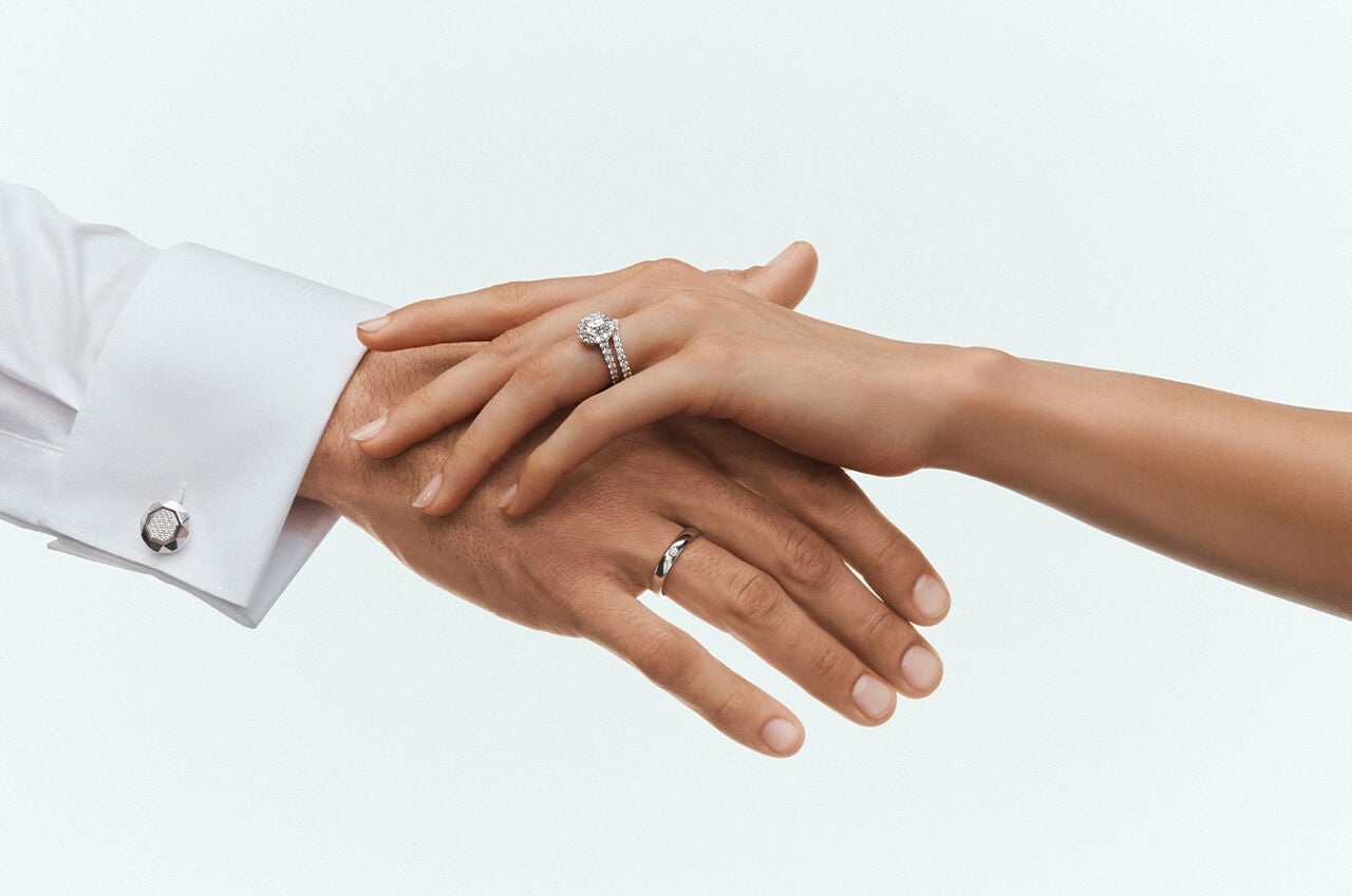 Bridal Guides - image shows female and male model hands wearing Graff Engagement Ring and Wedding Bands