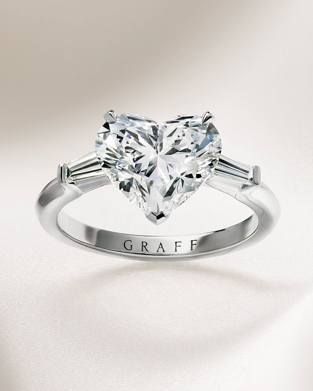 Image shows Graff Oval Diamond engagement ring and Graff round diamond wedding band 