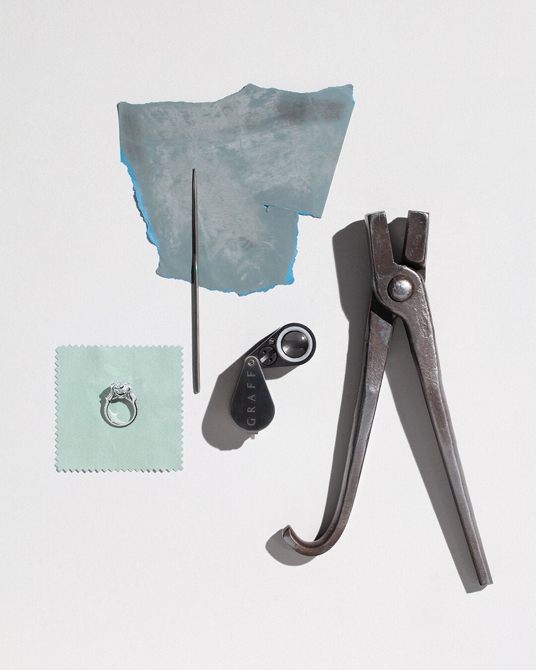 Guide to diamond certification - image shows Graff diamond engagement ring and workshop tools