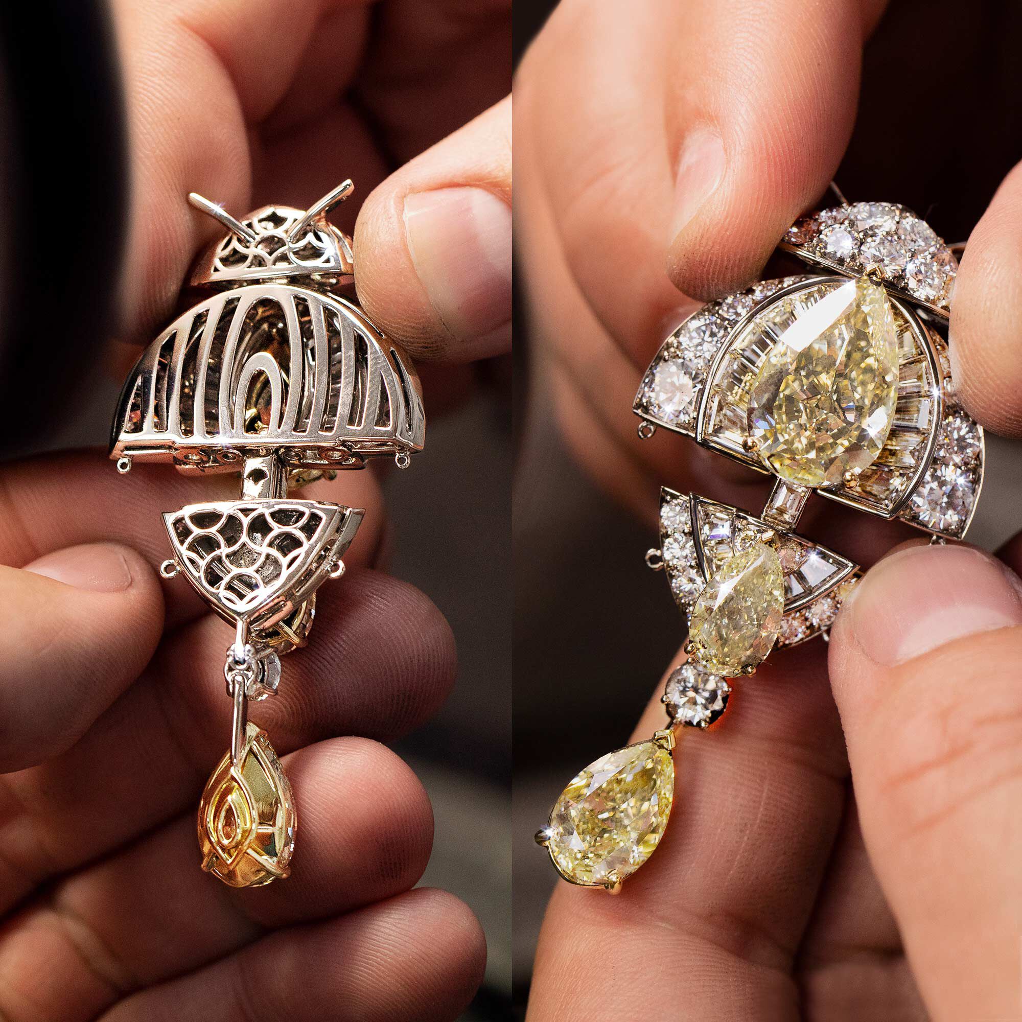 Craftsman holding a Graff yellow and white diamond high jewellery pendant