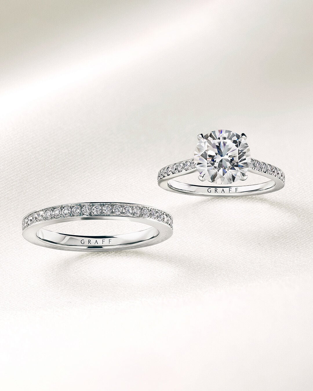 Image shows Graff Flame Round Icon diamond engagement ring and diamond Wedding Band 